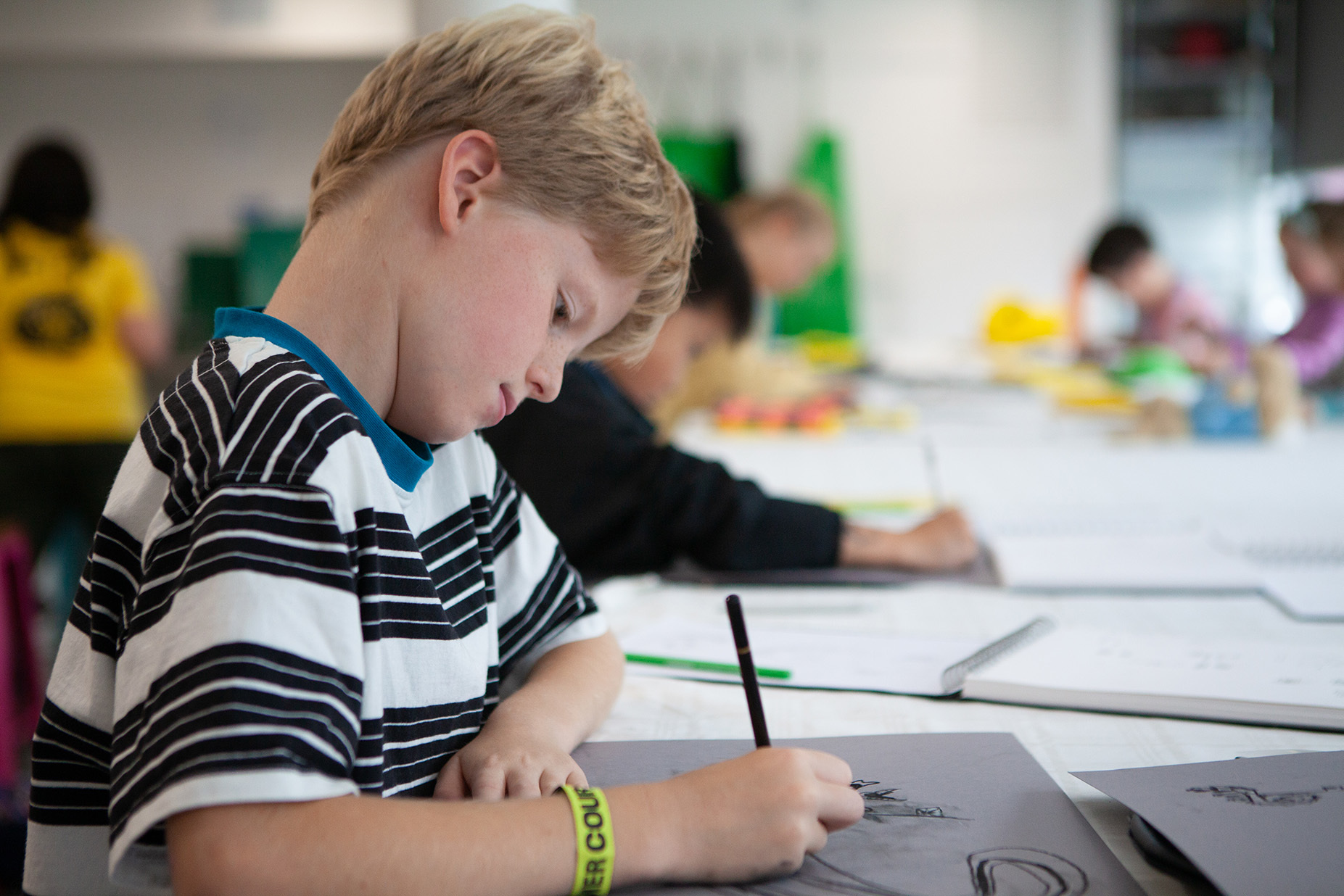 A young student is drawing