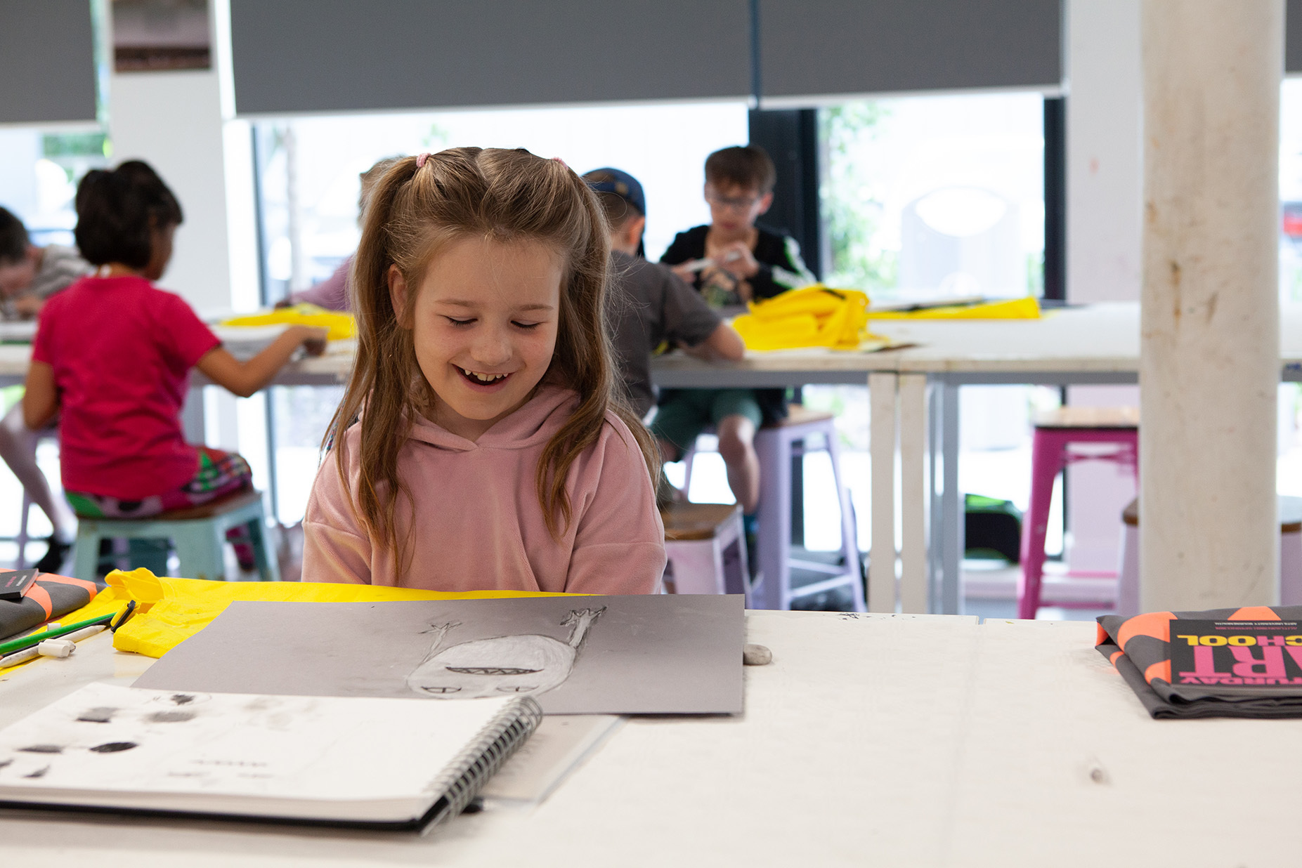 A young student is drawing in a sketchbook