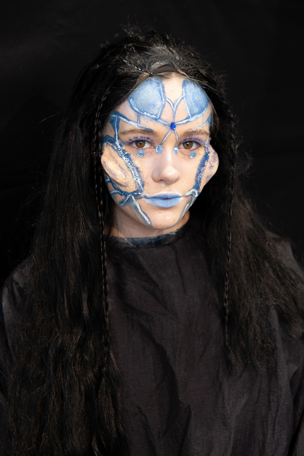 An example of character makeup:  a student has underwater-inspired makeup and lumpy prosthetics to make their cheeks stick out