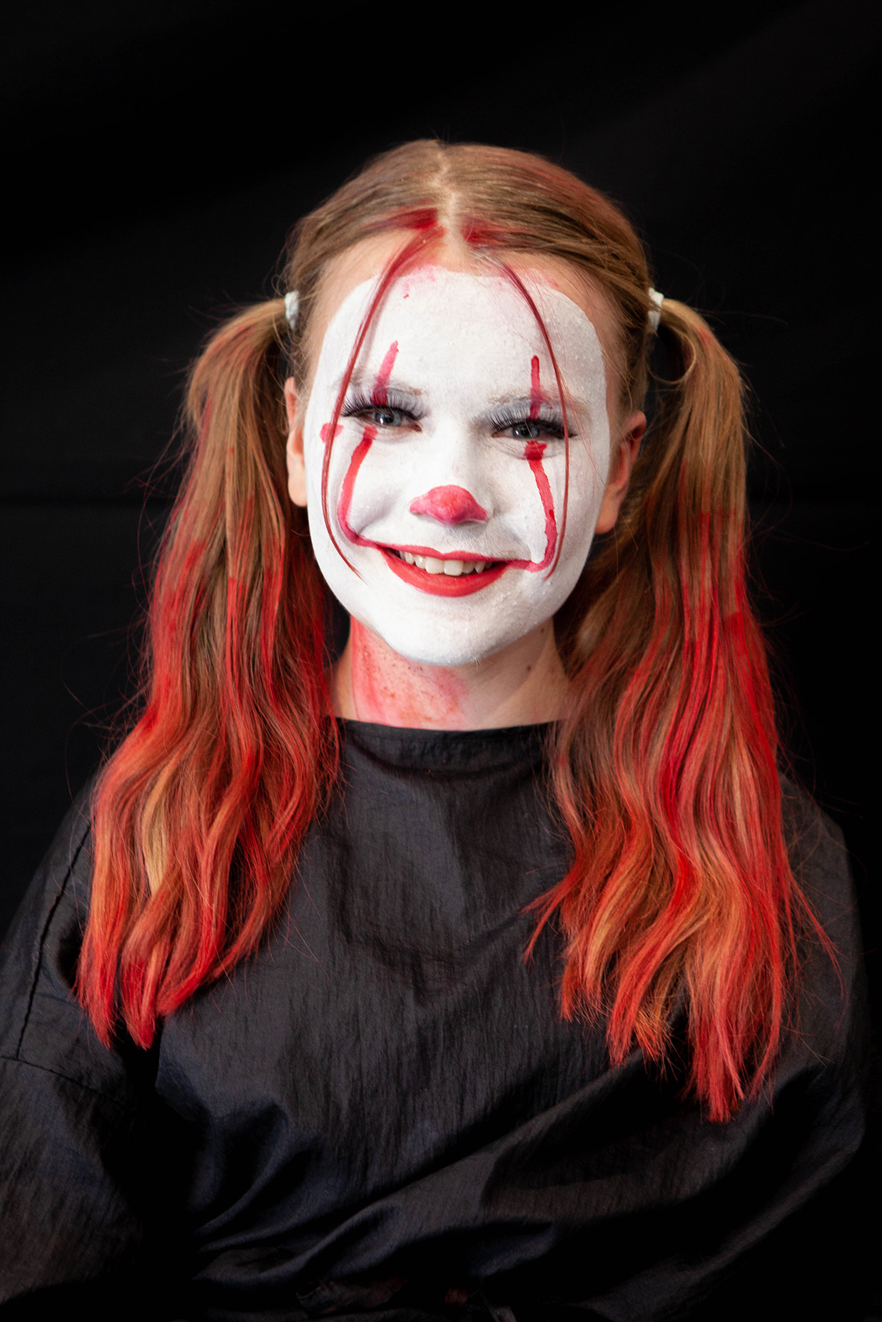 An example of character makeup: a student's face is painted like a clown