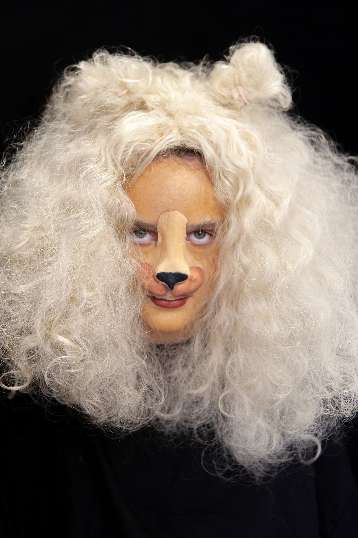 An example of character makeup: student has a fluffy white wig on and face paint to look like a dog