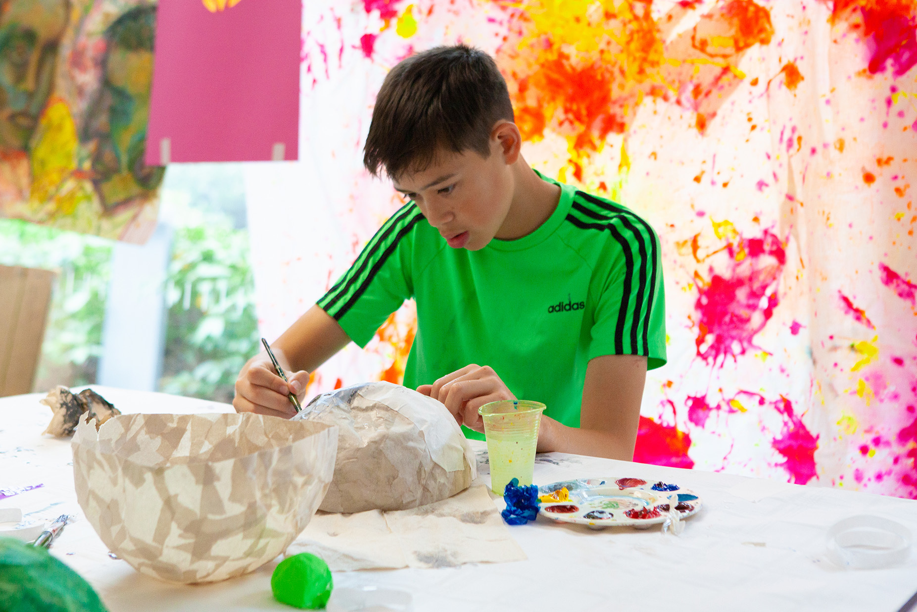 A young student is painting
