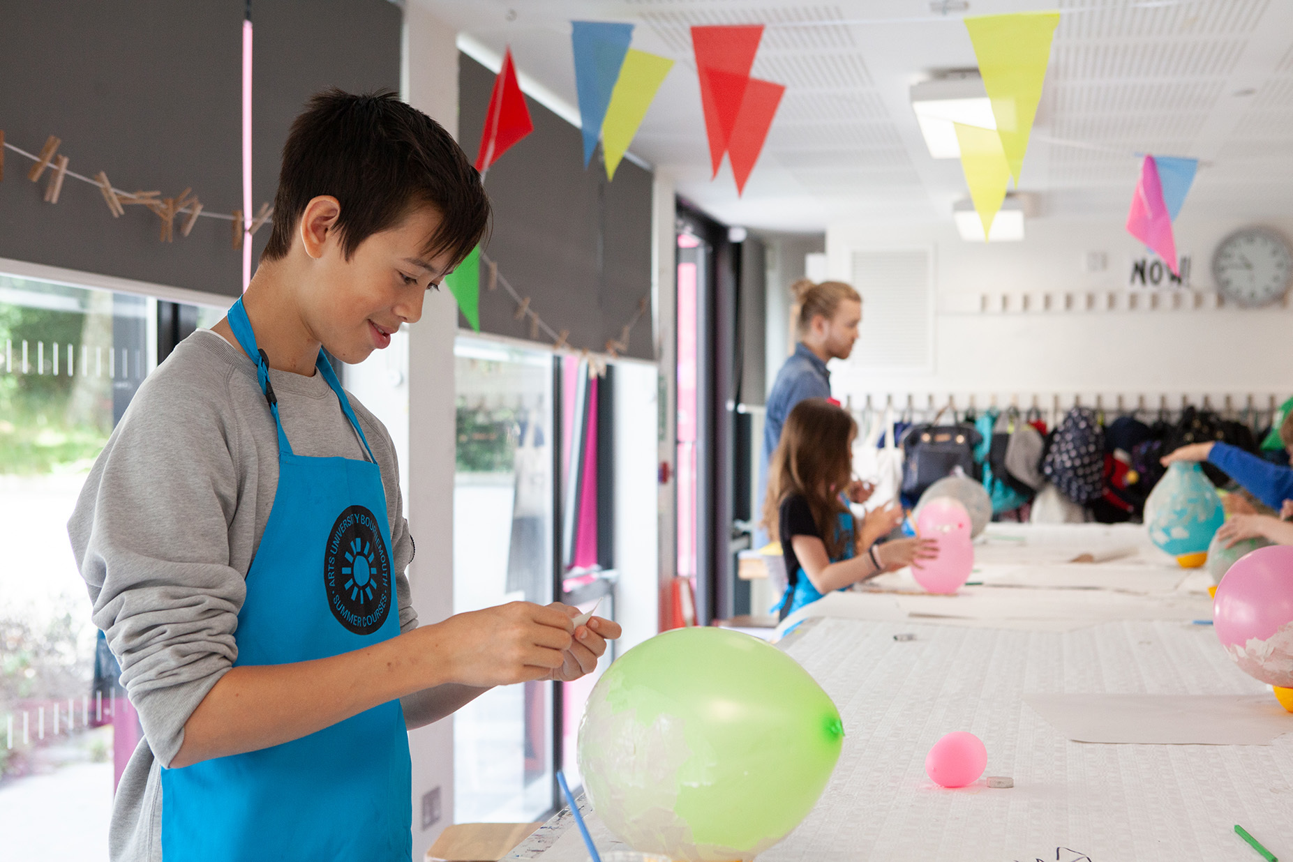 A student is preparing to papier mache