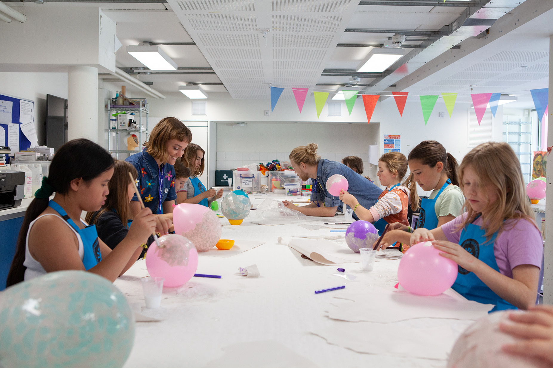 A group of students are preparing to make papier mache