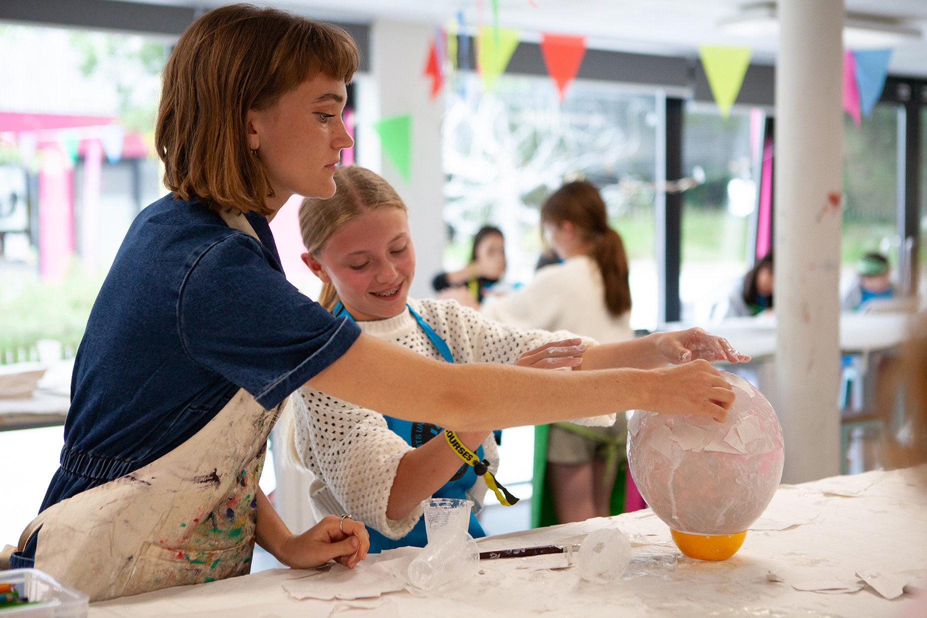 A student is making a papier mache sculpture