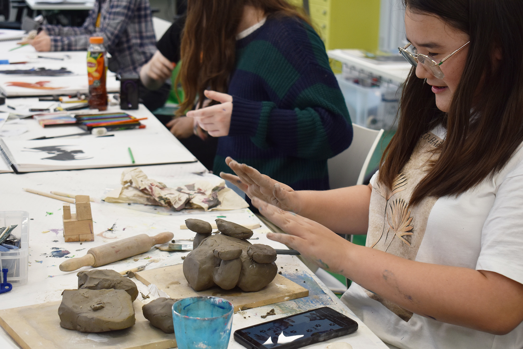 A student is moulding with clay