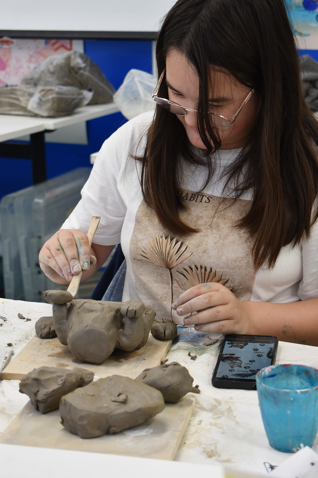 A student is moulding with clay
