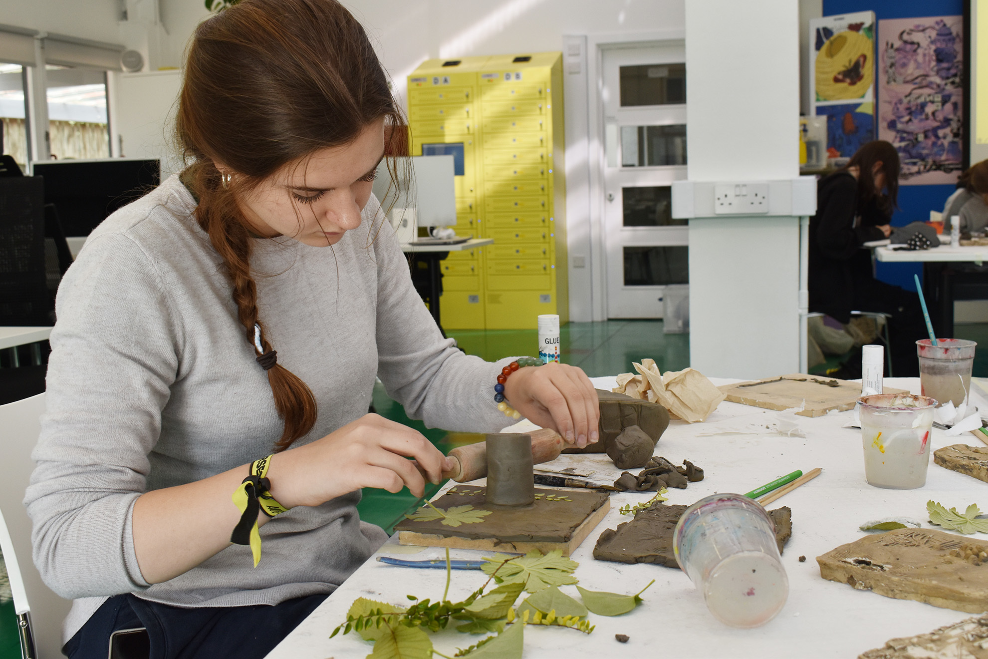 Students working with clay