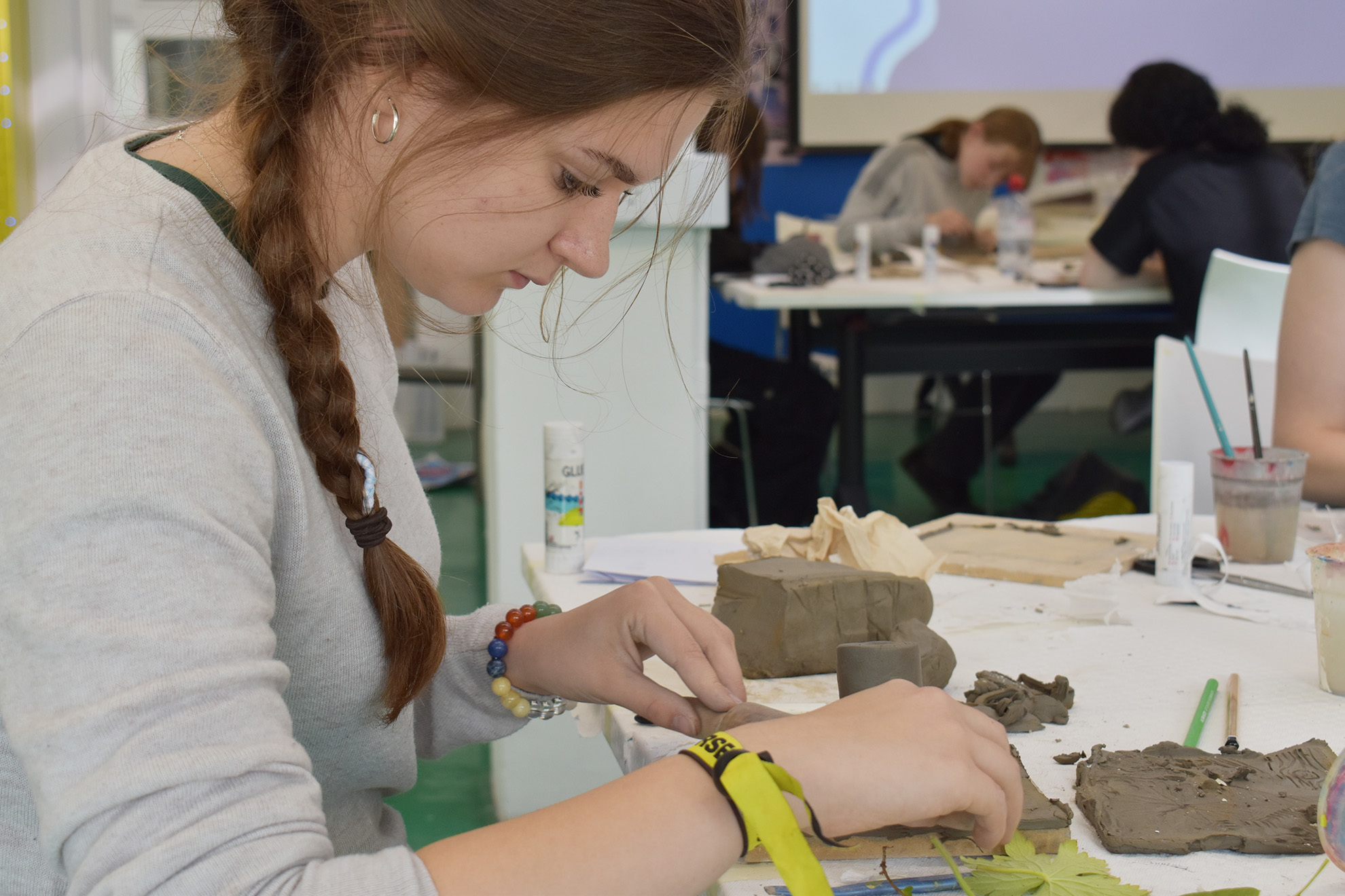 Students working with clay