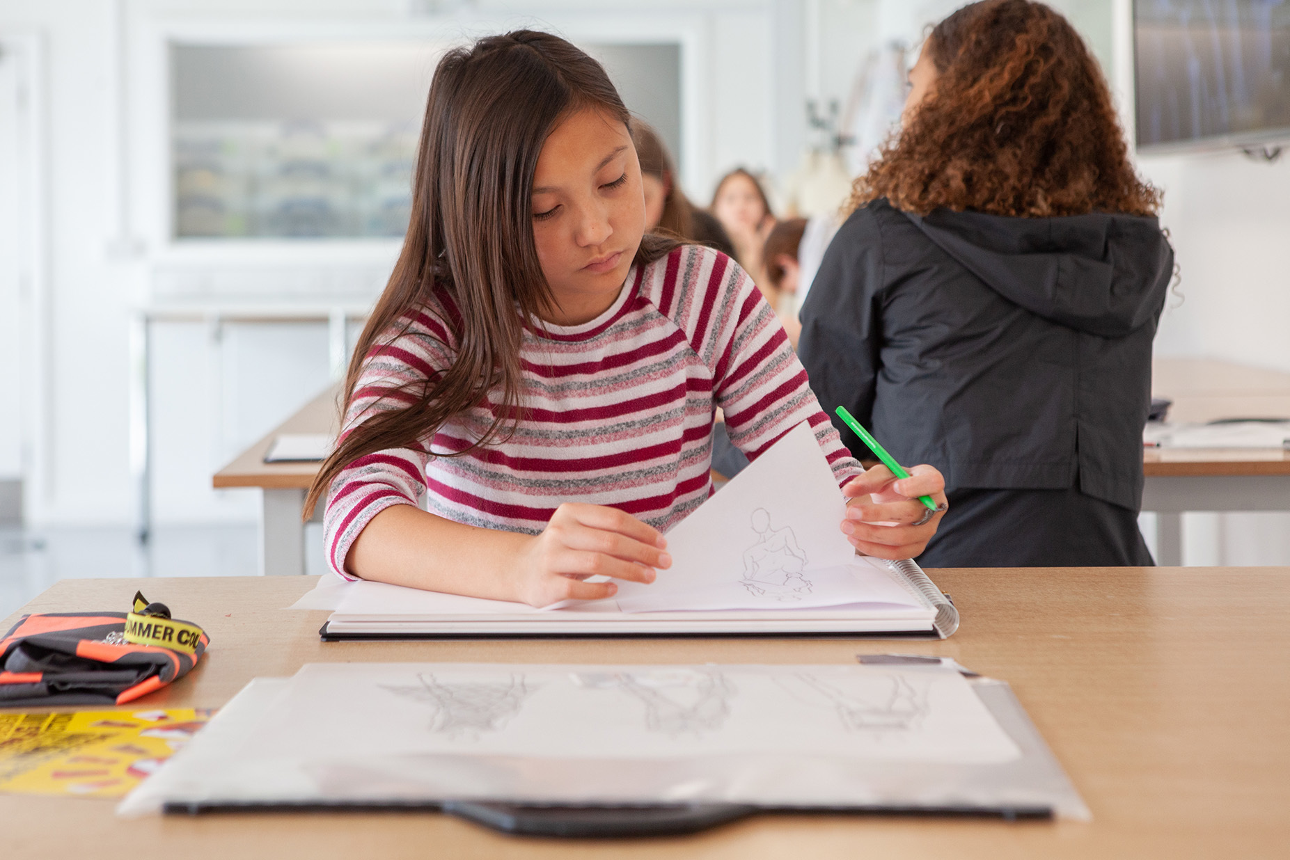 A student is sketching