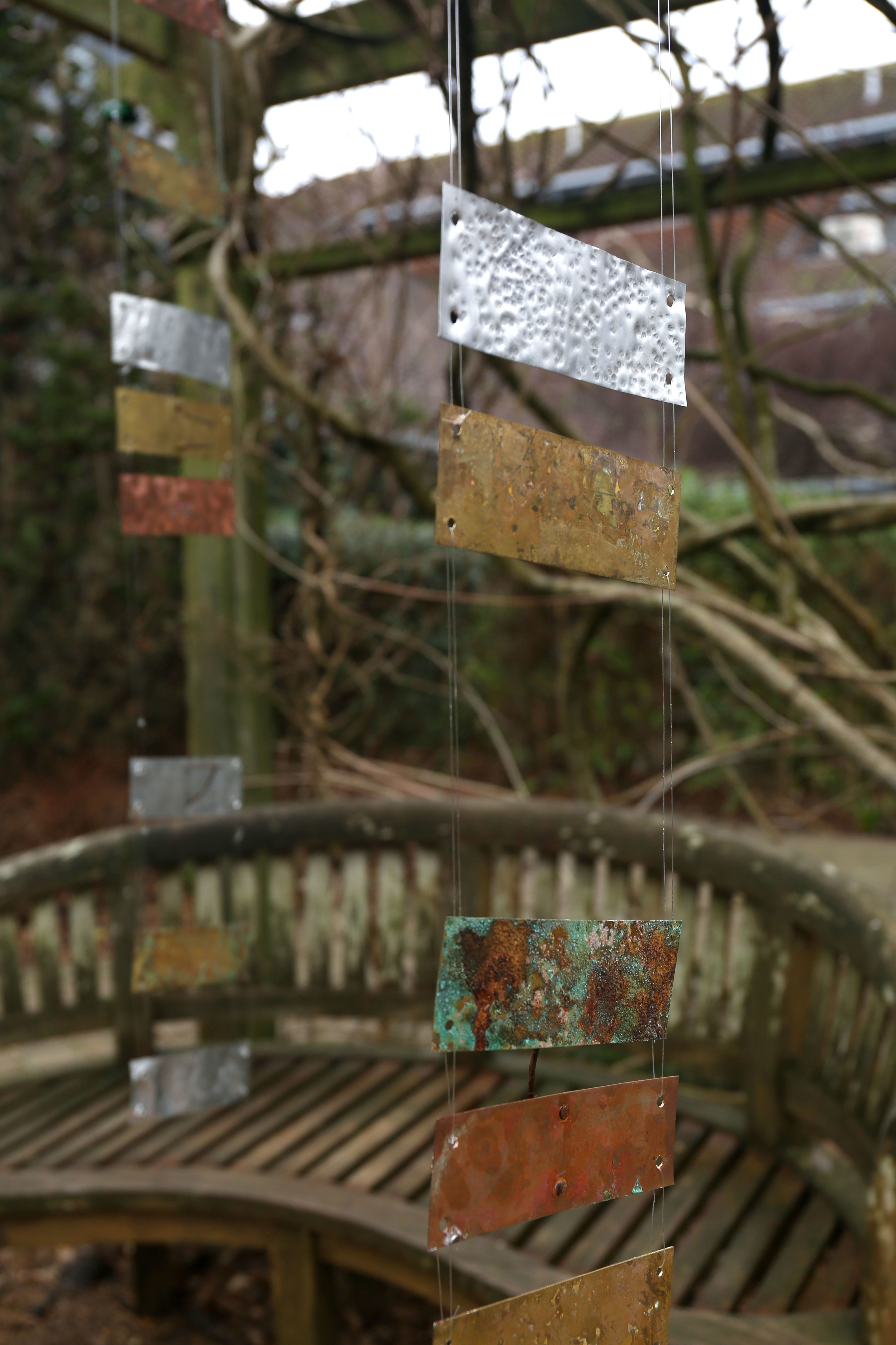 Metal plaques hung on string in the AUB courtyard.