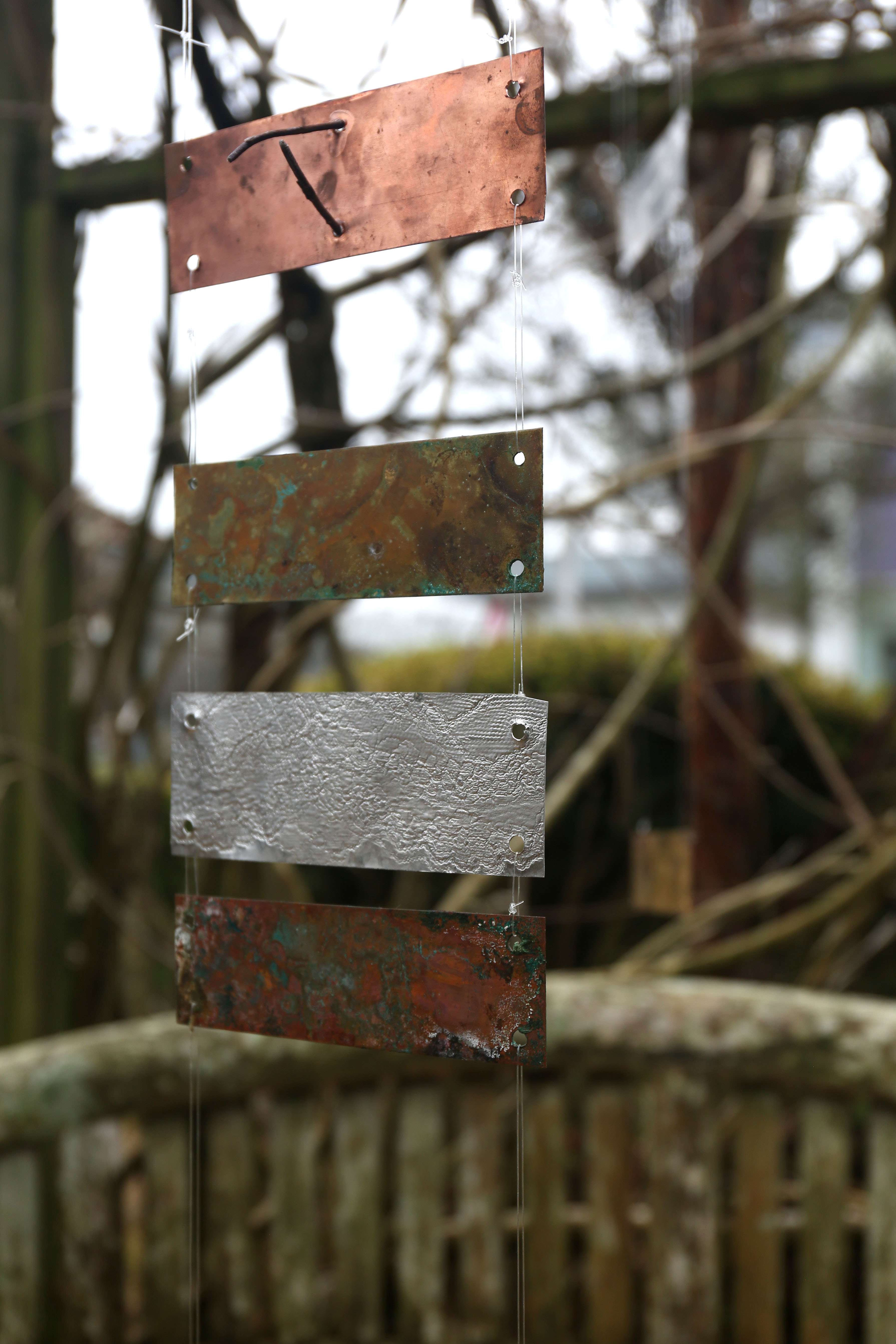 Metal plaques hung on string in the AUB courtyard.
