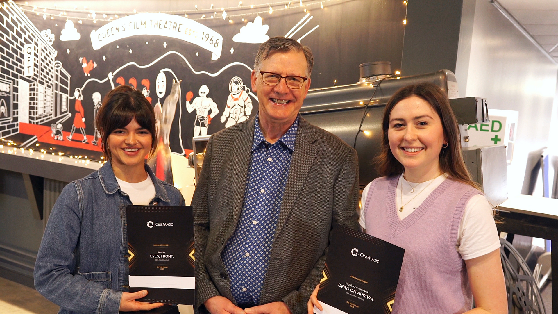 BA (Hons) Film Production graduate A. Wheeler standing with two others holding her On the Pulse Award.
