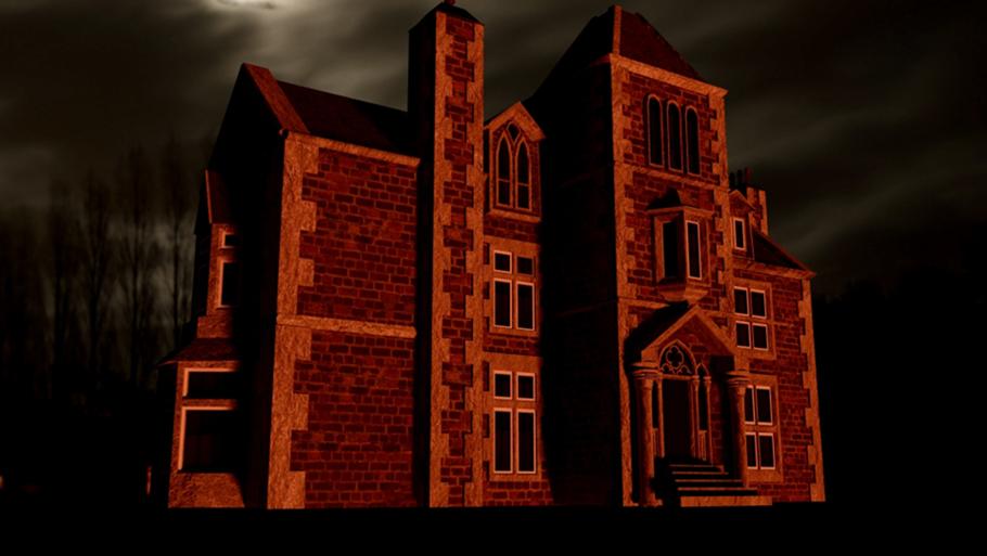 A brick manor house viewed at night