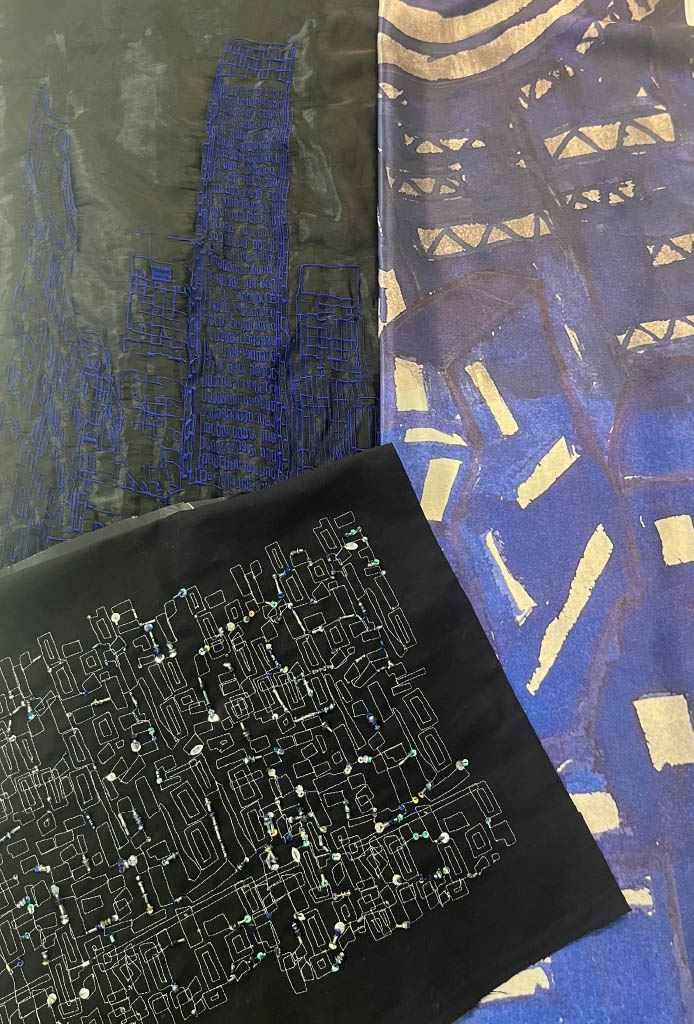 Three fabric pieces displayed together: one in black with a geometric design in white, a blue and patterned fabric with abstract shapes, and another in a lighter blue with faint lines and shapes suggestive of a cityscape.