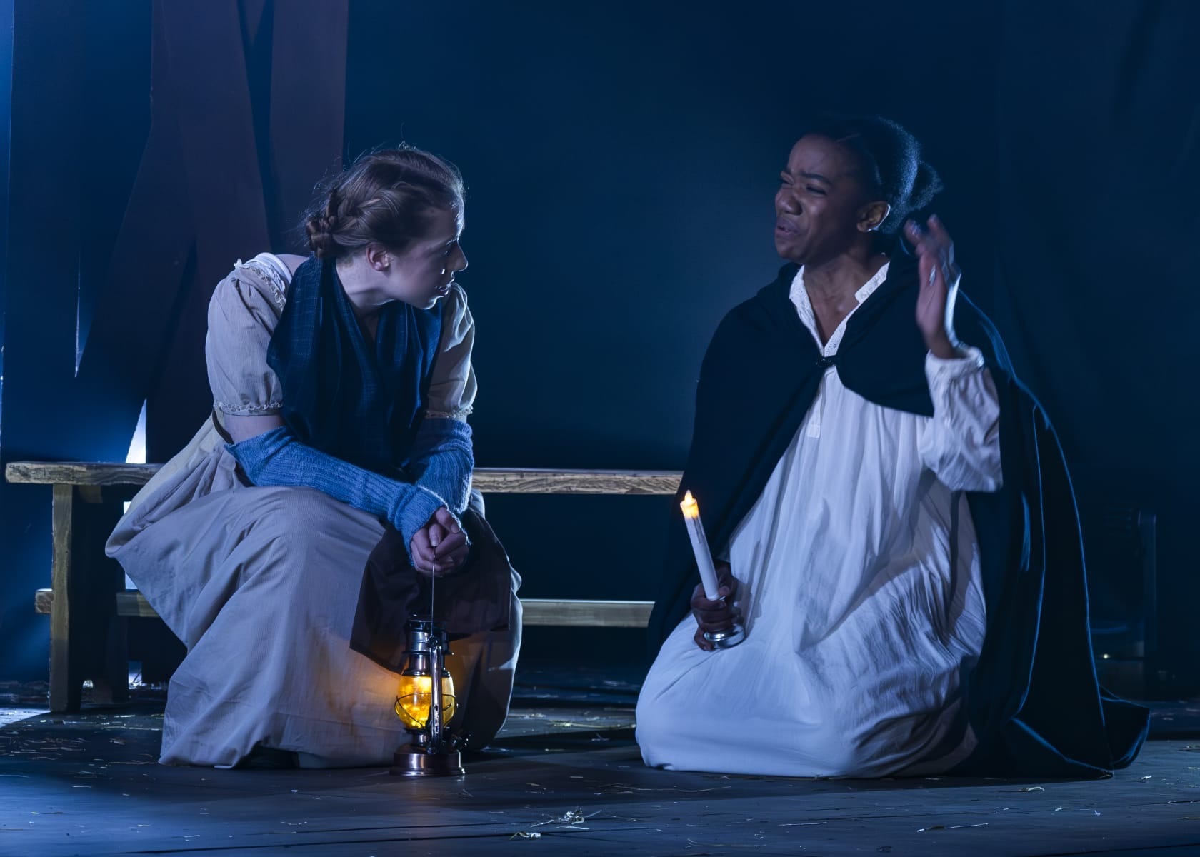 Nicole Elizabeth Phillip in The Ballad of Maria Marten with another actor, blue lighting.