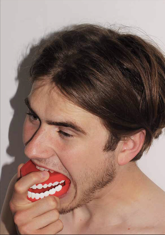 Man with teeth toy in mouth