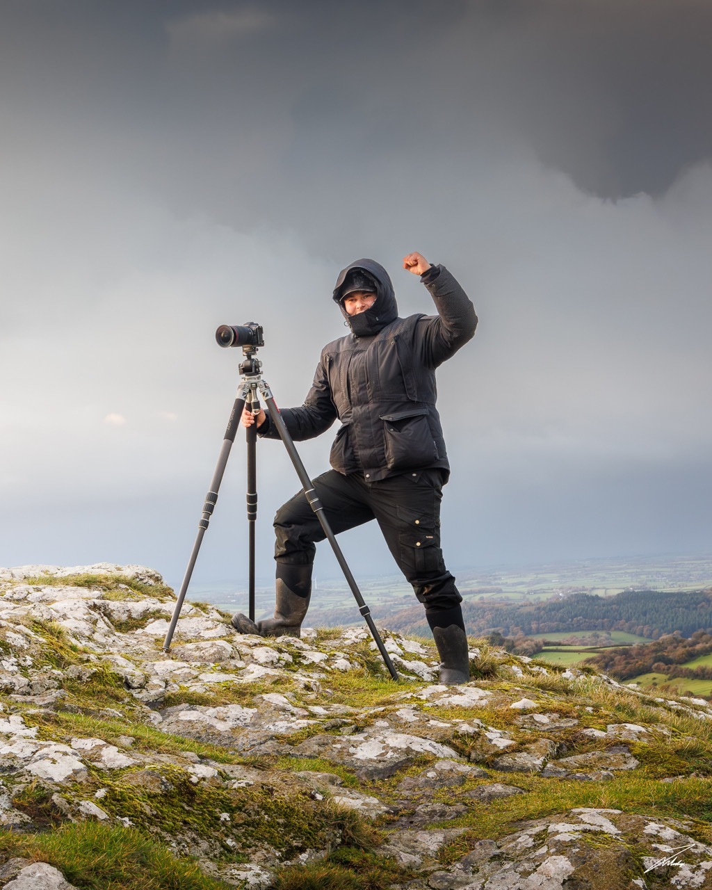 Jack Lodge on a rocky outcrop with his photography equipment