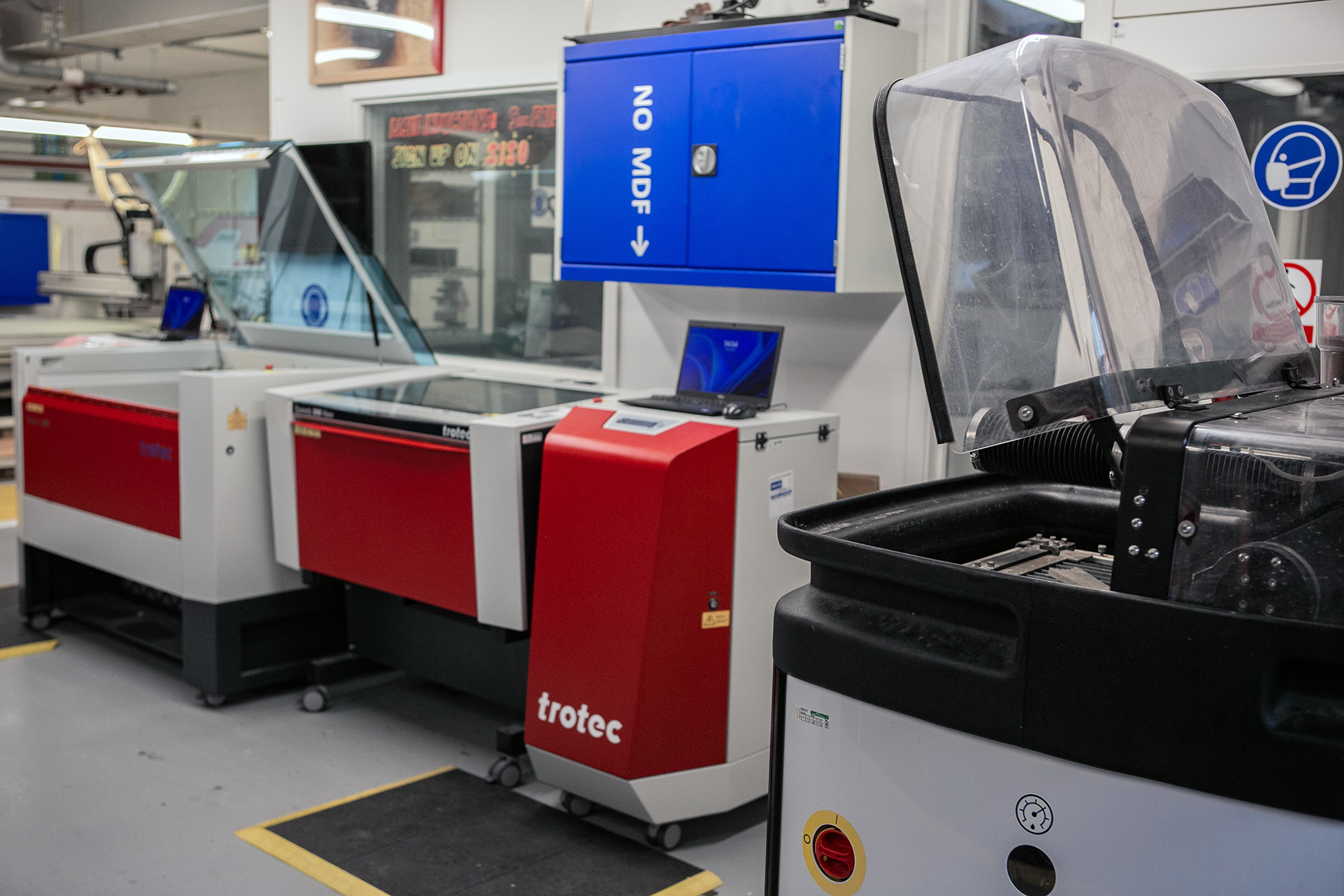 2D Cutting and engraving machines in a technical studio, red and blue.
