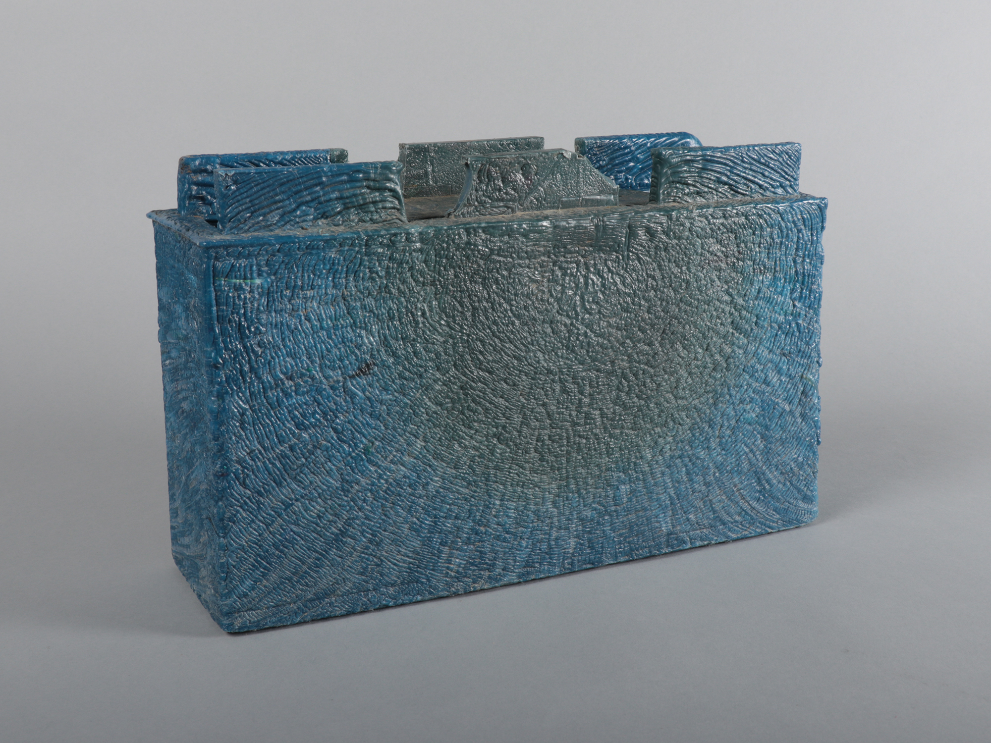 A brick with six small protrusions carved into it at the top.