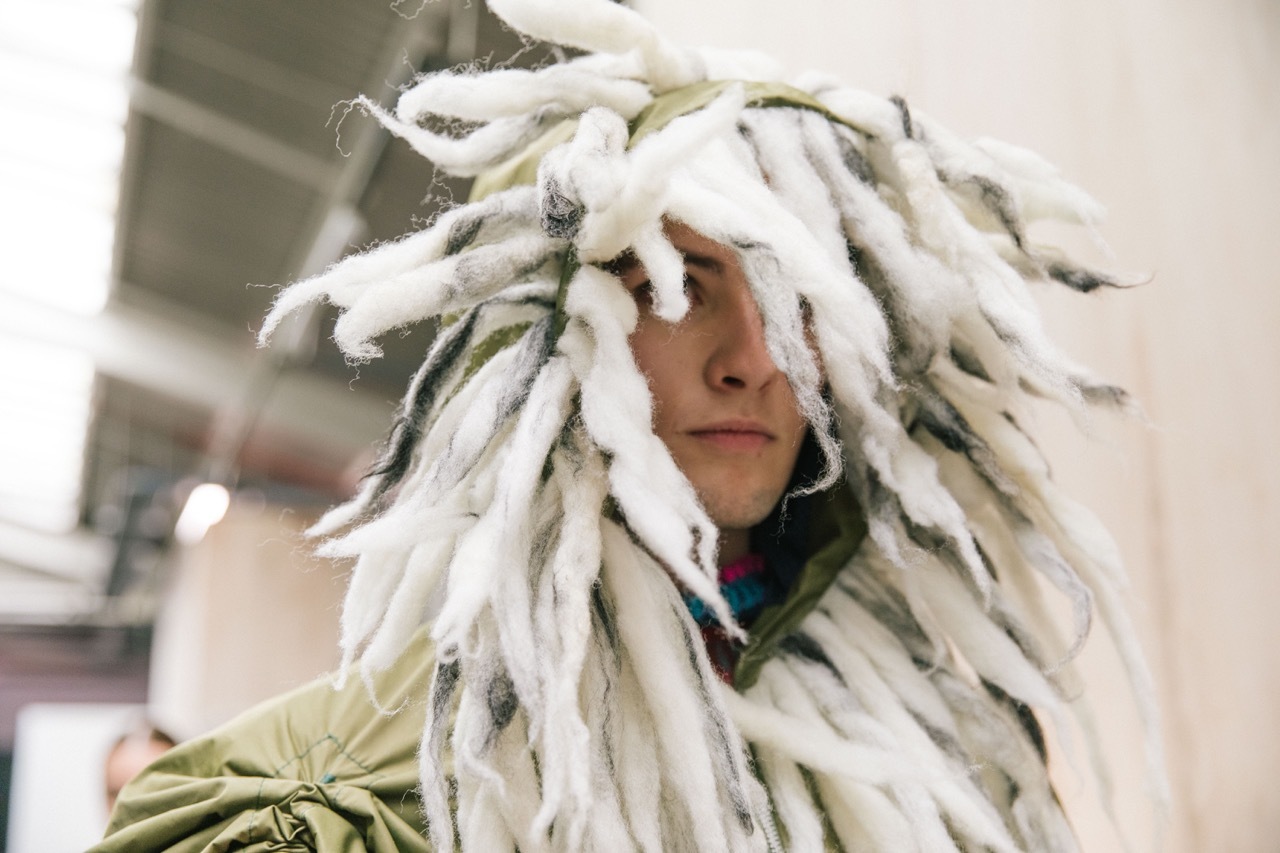 A student model wearing a wool hood for Graduate Fashion Week 2023