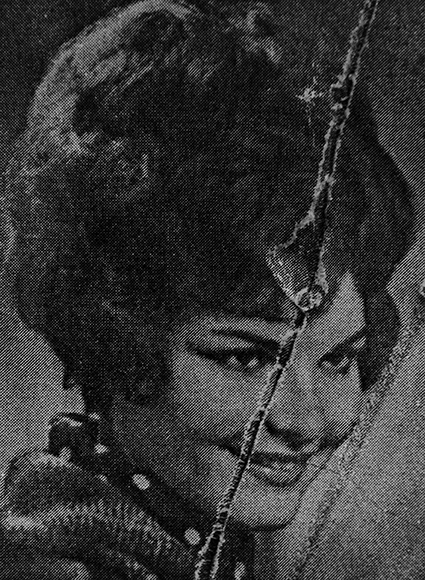 Black and white ripped photograph of lady