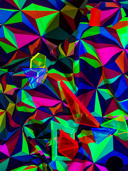 Abstract artwork made up of assorted multicoloured triangles.