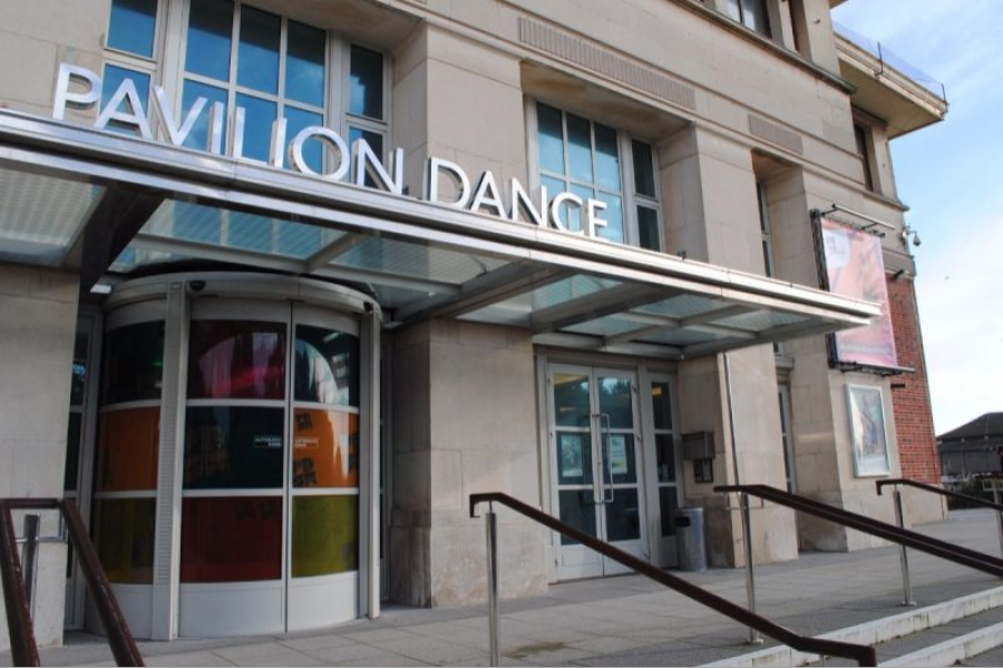 Front steps and entrance of a theatre building. A sign reading 'Pavilion Dance' appears over the front door.