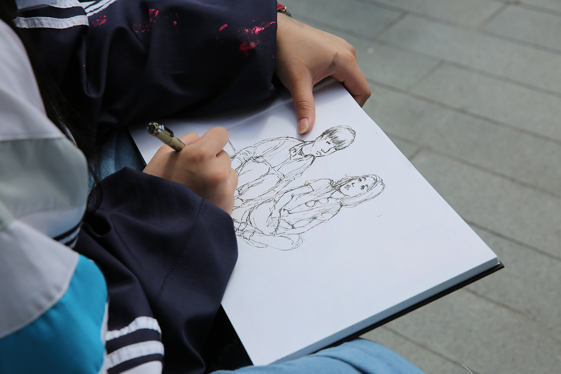 Student drawing in sketch book