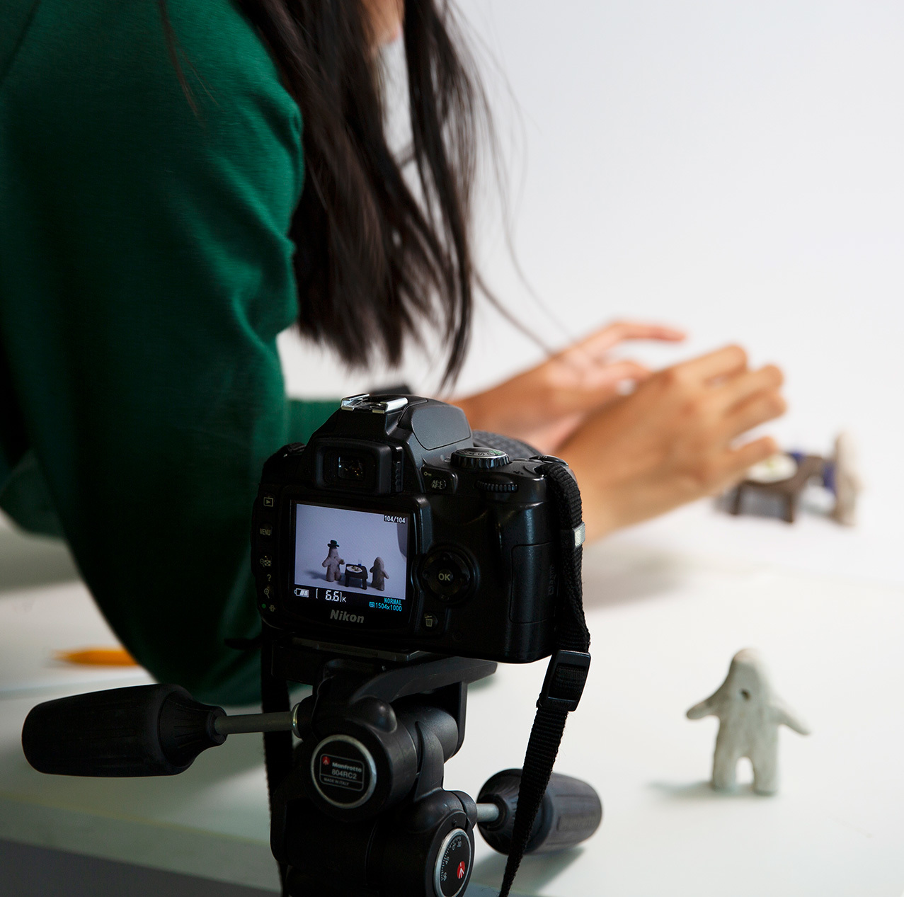 Student arranging models for stop motion animation