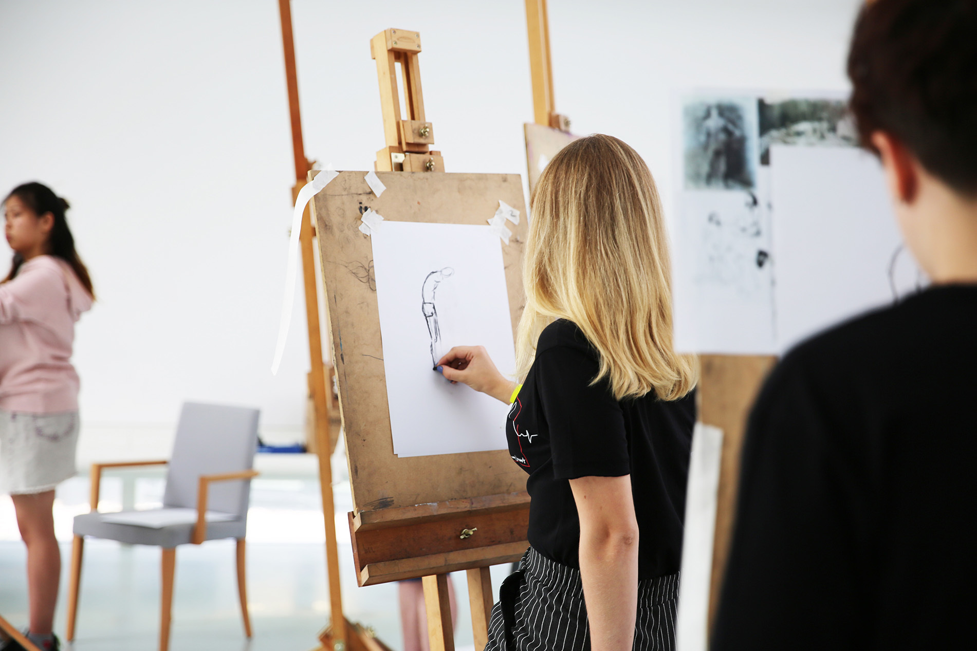 Student drawing on easel
