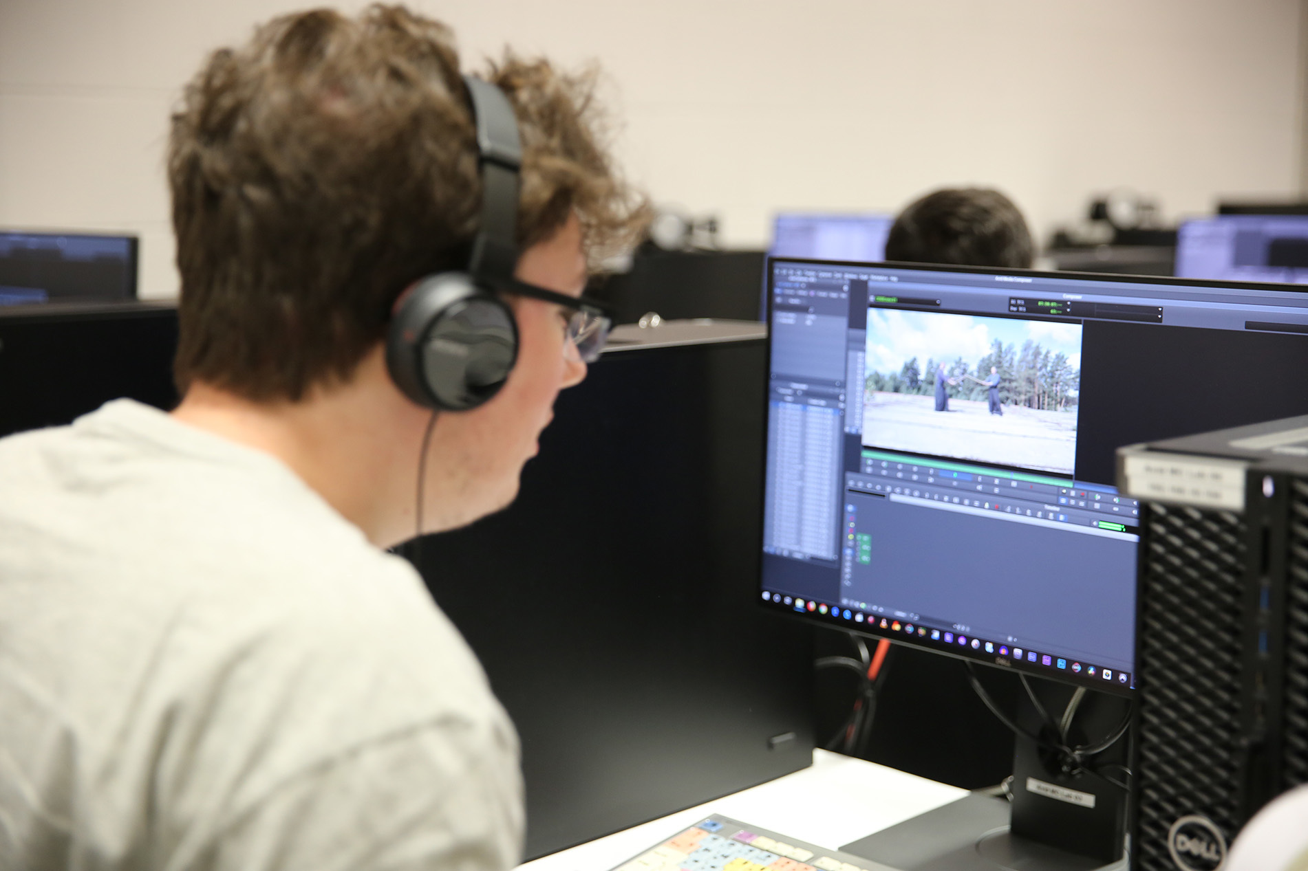 Student editing film on computer