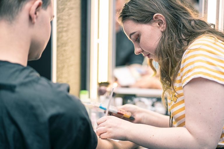 Naimh applying Prosthetics to her model at the IMATS