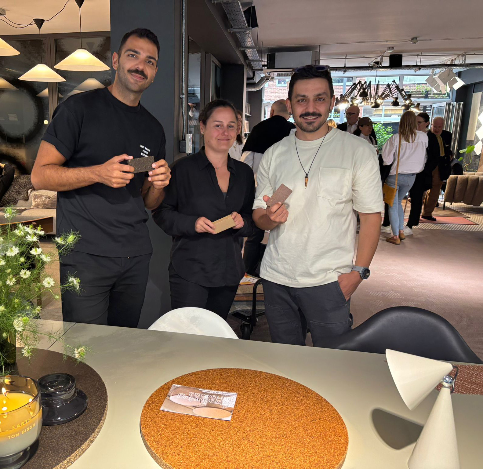 M Afşaroğlu, Y Fellahoglu and B Ebeler all holding samples of the sustainable material Pit-Board at a Clerkenwell Design Week event.
