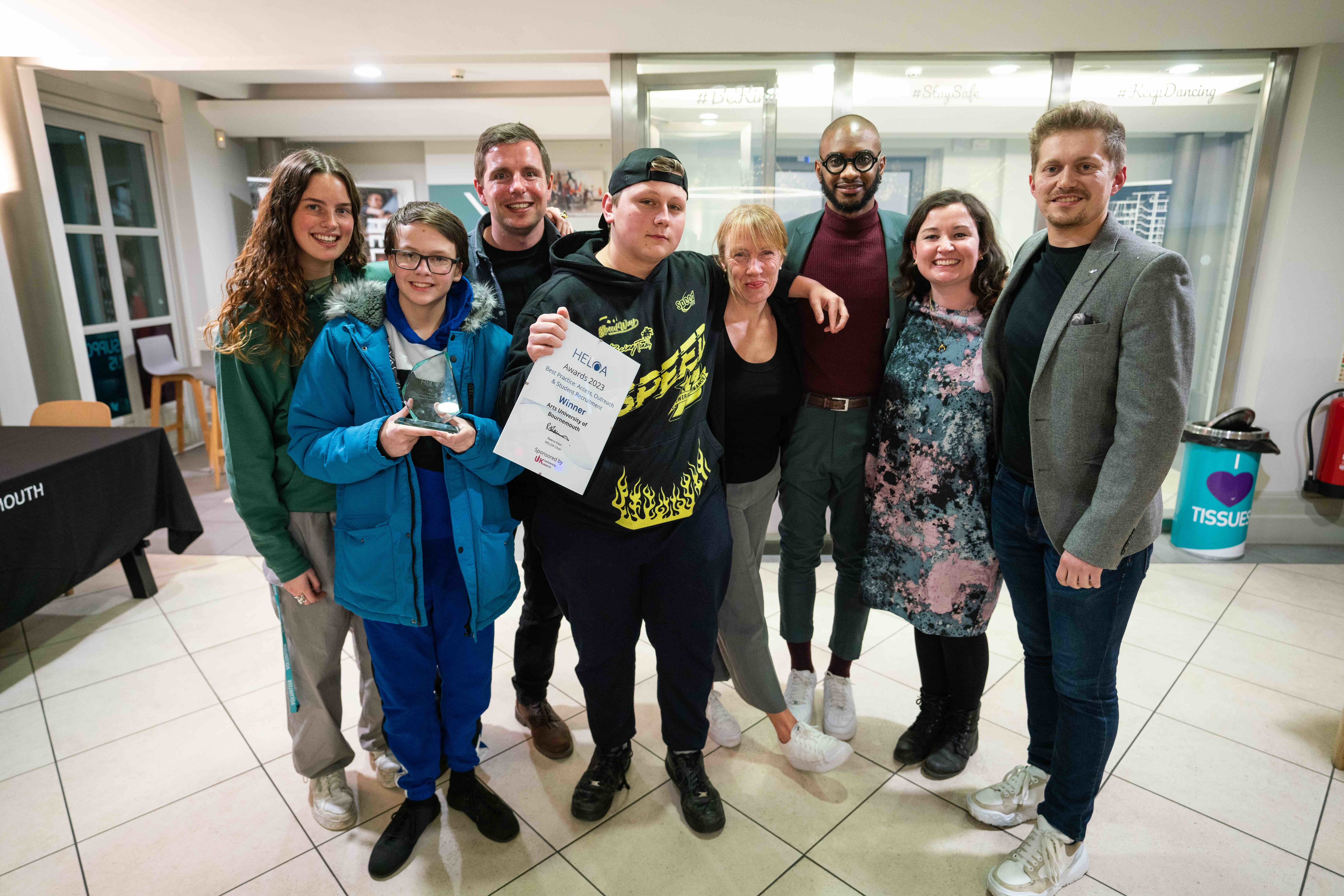 The 2022 Being a Boy project group. A group of people stand and pose for a photo. One of them is holding a certificate.