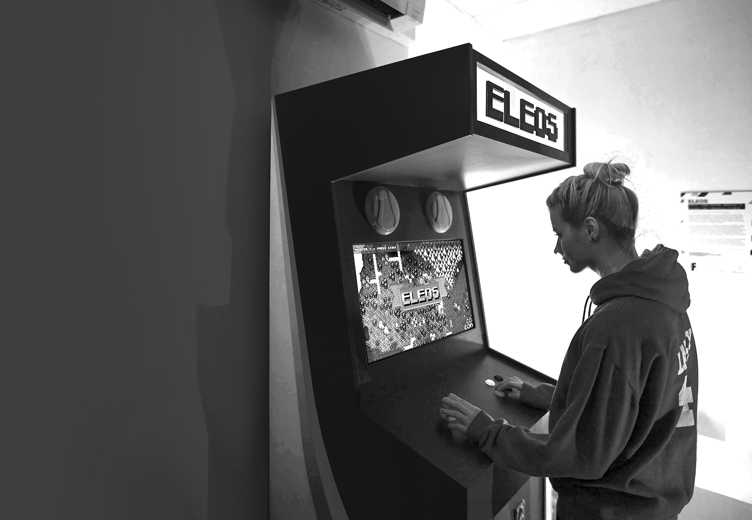 Black and white image of someone playing a retro game