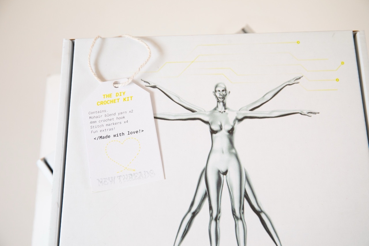 Mock-up box for New Threads packaging showing a metallic figure in the Leonardo Da Vinci pose.