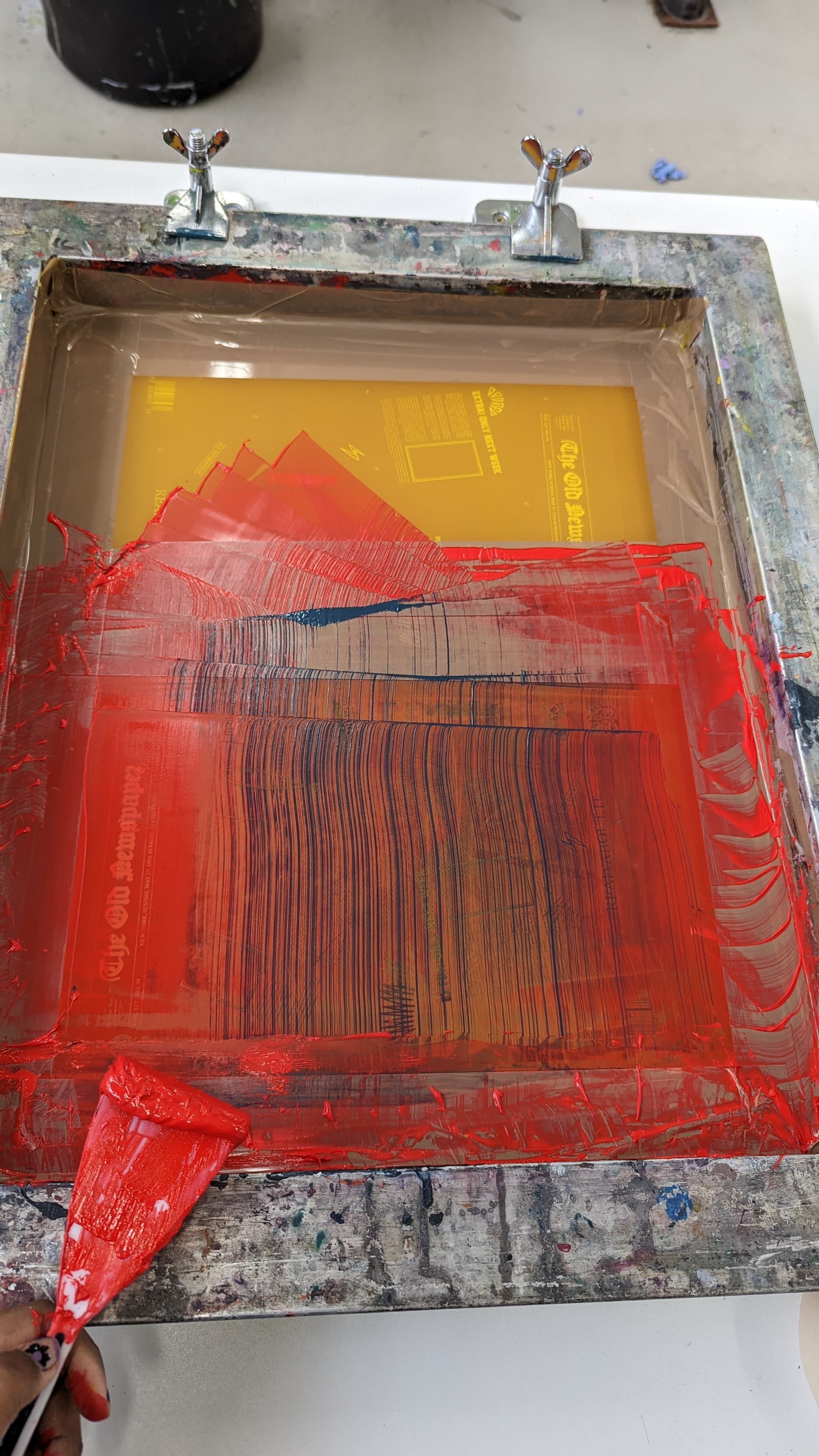 A screen printer with red and black paints