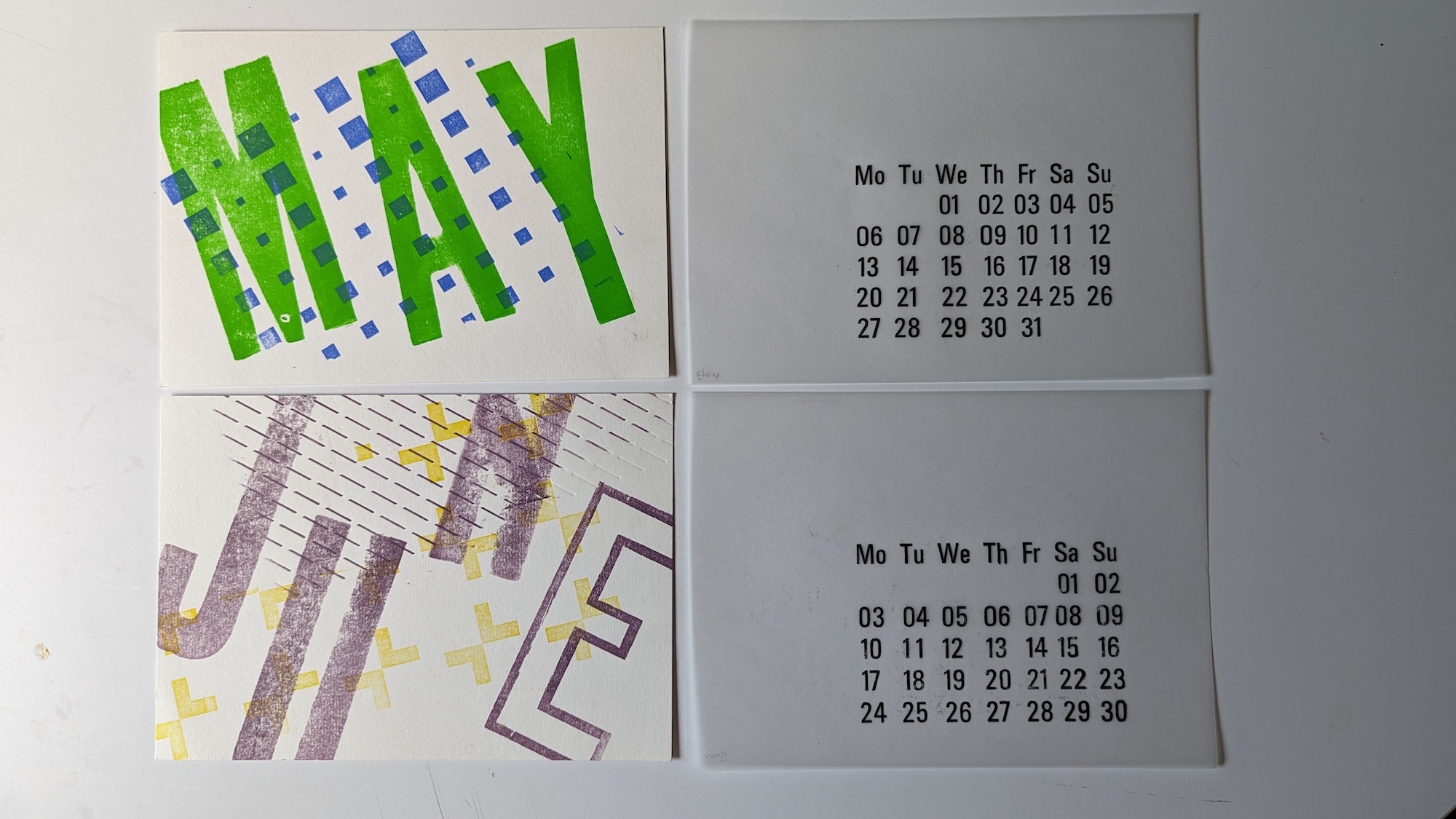 Colourful blue and green graphics and calendar, text reads 'MAY, JUNE' on four pieces of paper, white background.