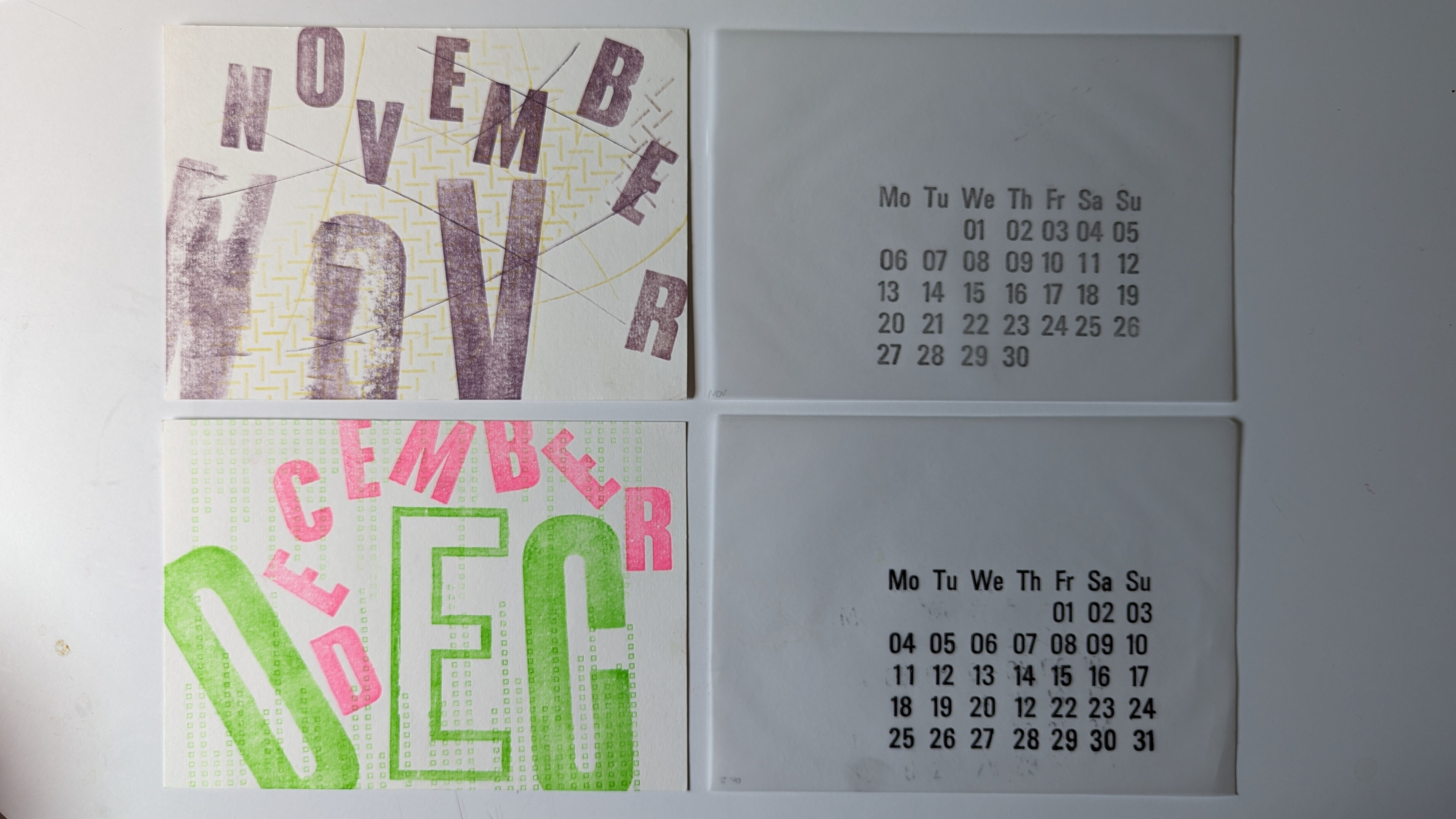 Colourful pink and green graphics and calendar, text reads 'NOVEMBER, DECEMBER' with scattered letters on four pieces of paper, white background.