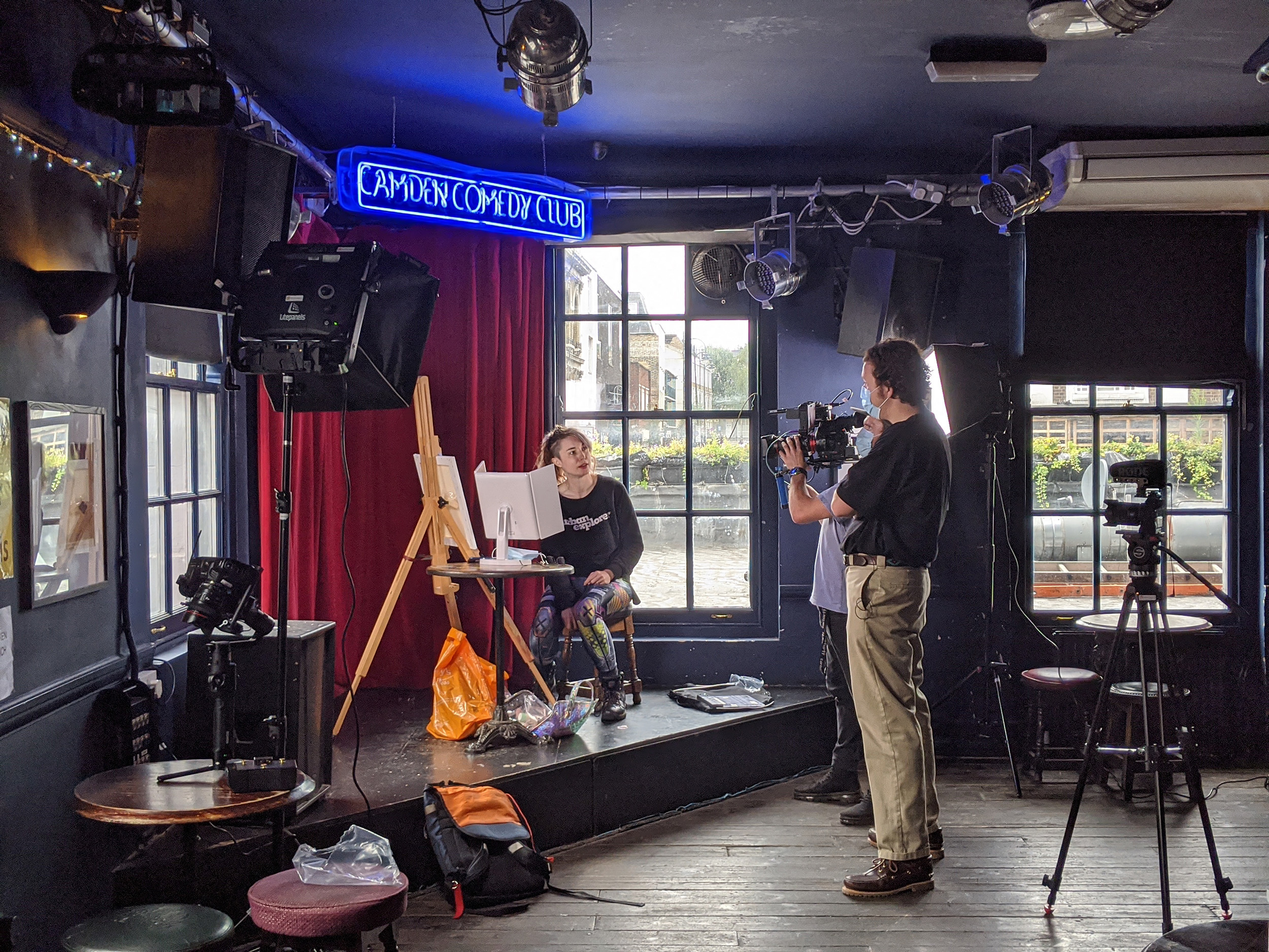 Behind the scenes of a comedian getting ready at the Camden Comedy Club in front of Louis Moir holding a film camera