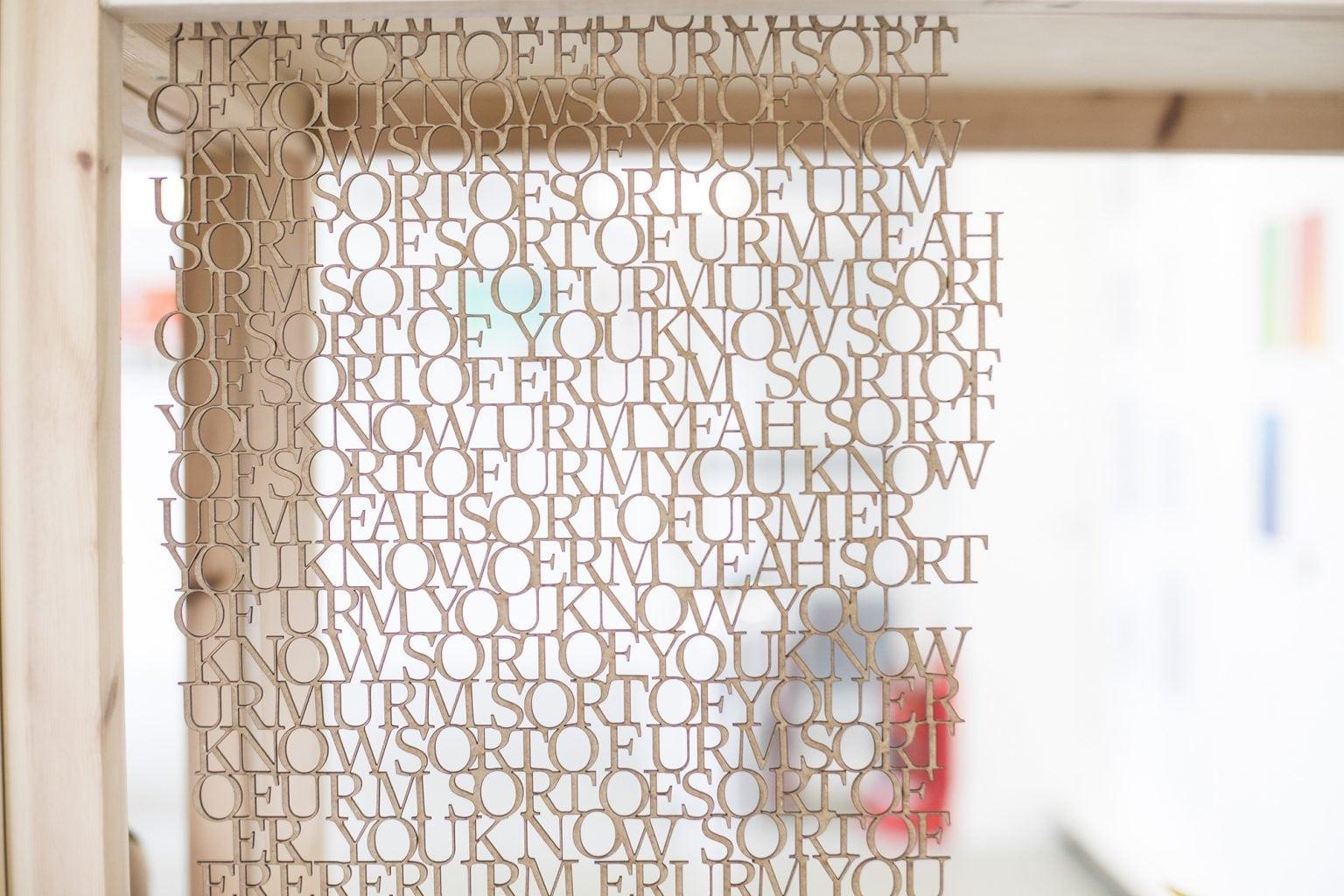 Piece of art work made up of words hanging down from the ceiling