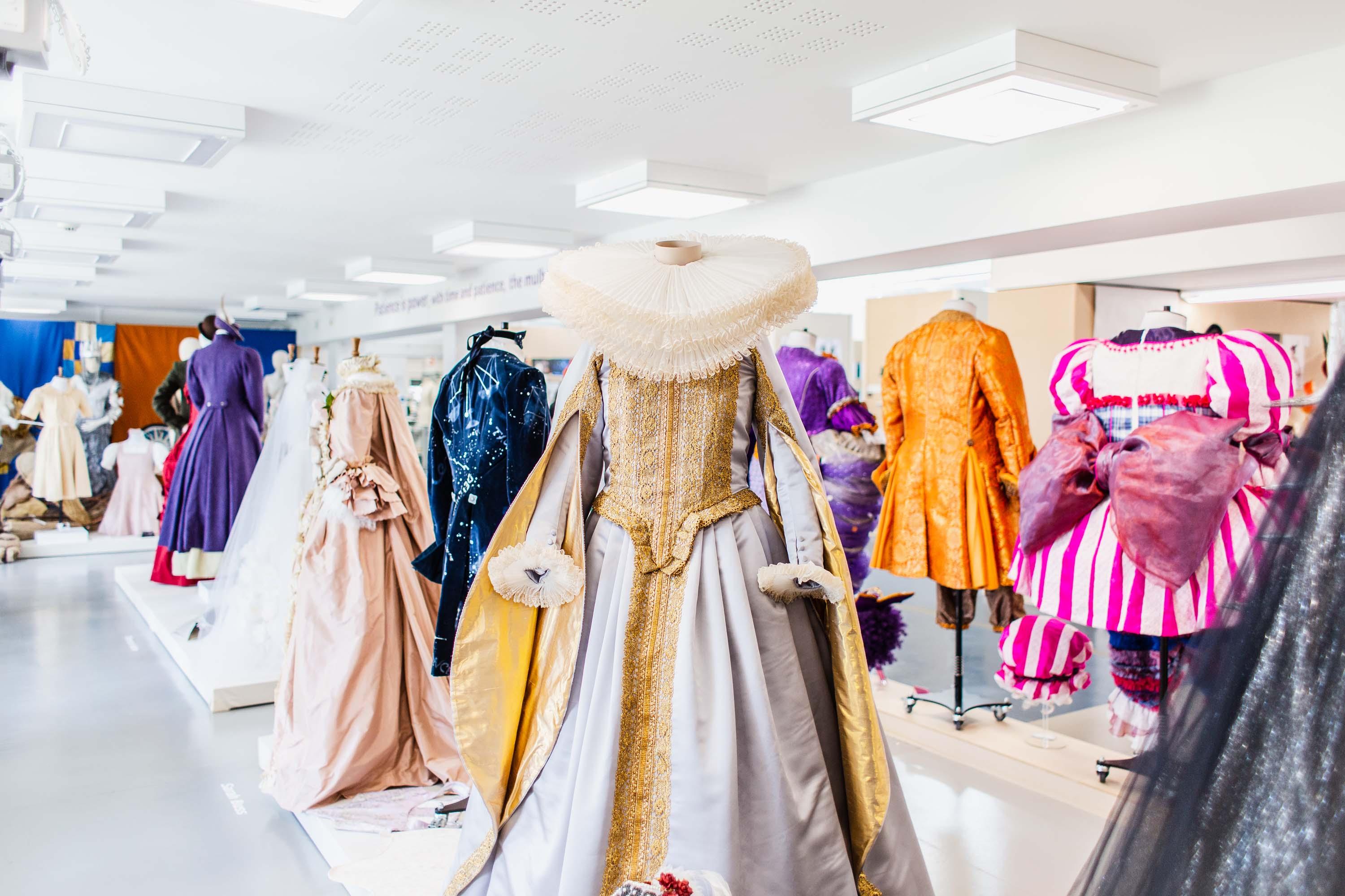 Mannequins displaying Victorian period-style costumes designed by students.