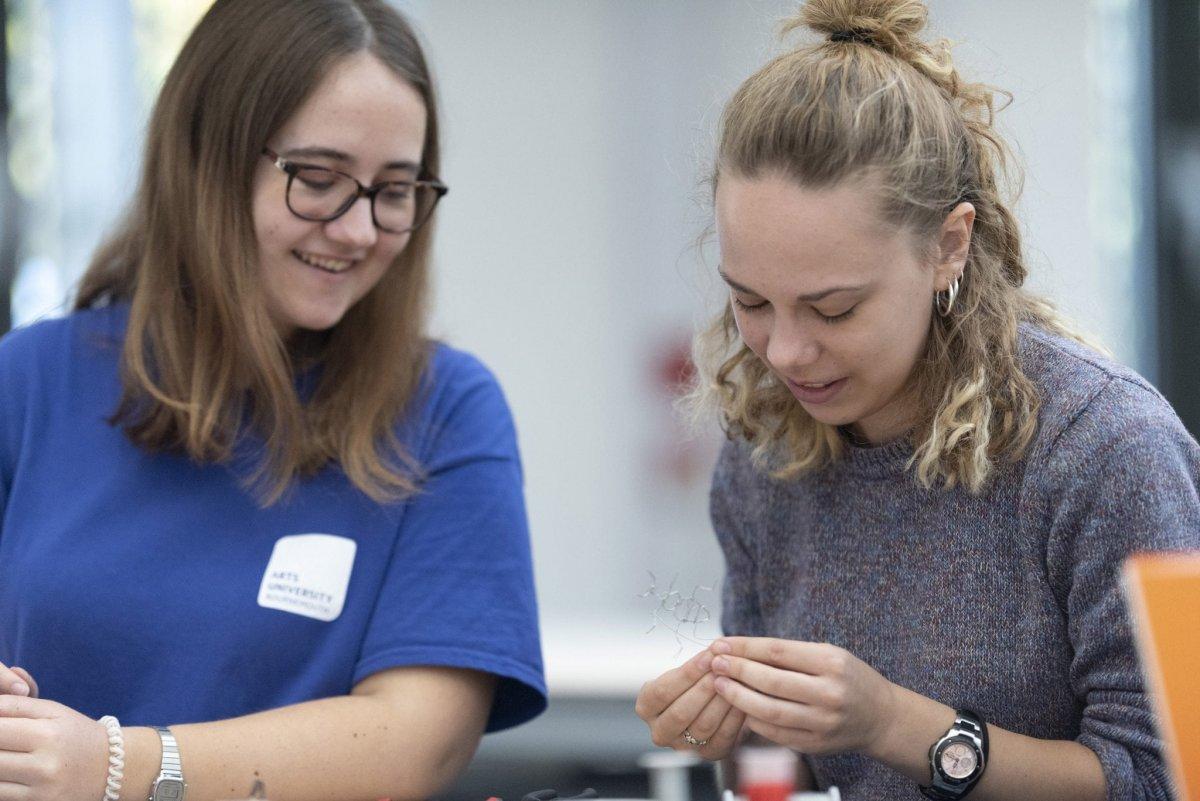 Student ambassador helping out a student at an open day workshop.
