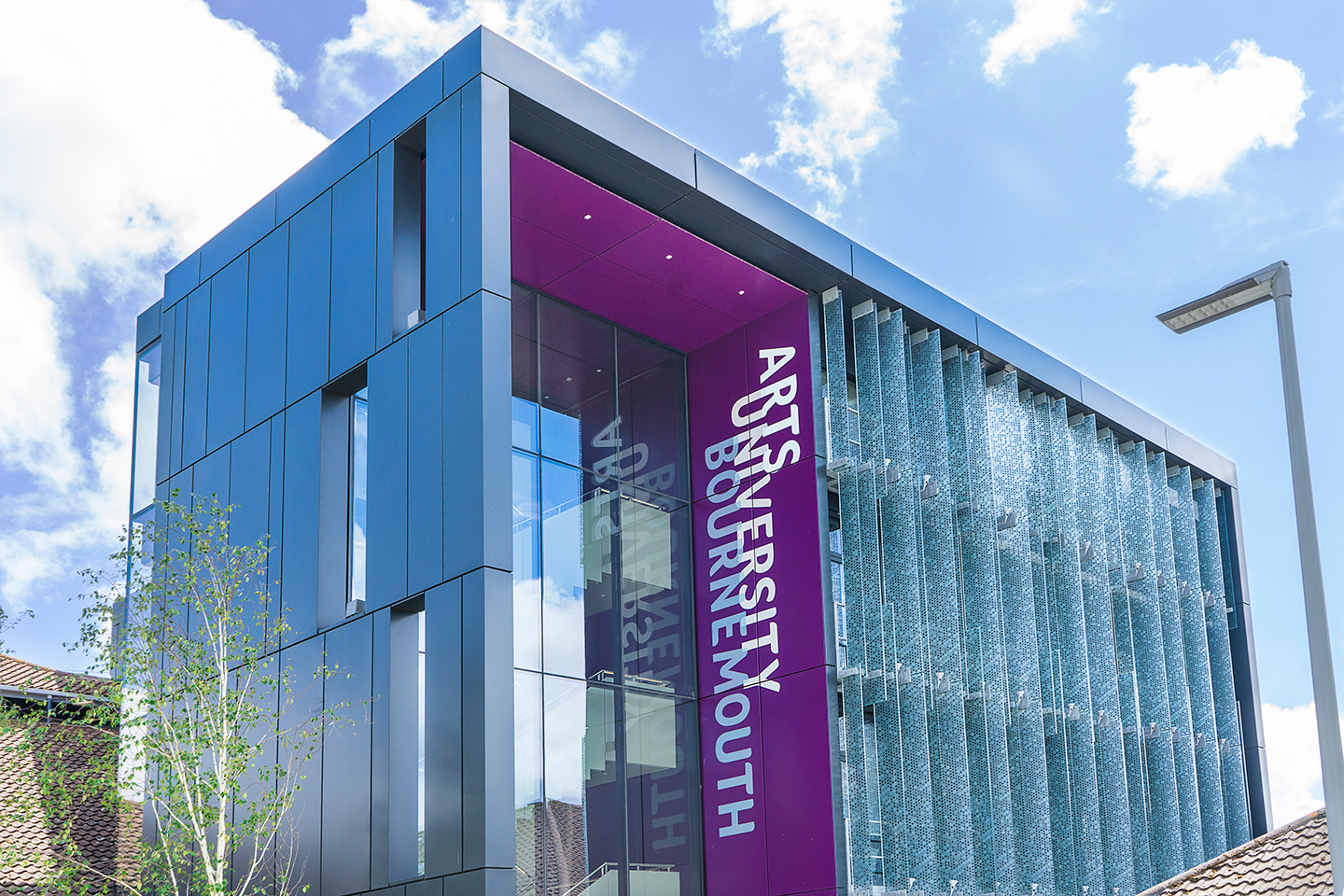 Outside one of the main campus buildings on AUB Campus. The words "Arts University Bournemouth" read vertically down the side of the building.