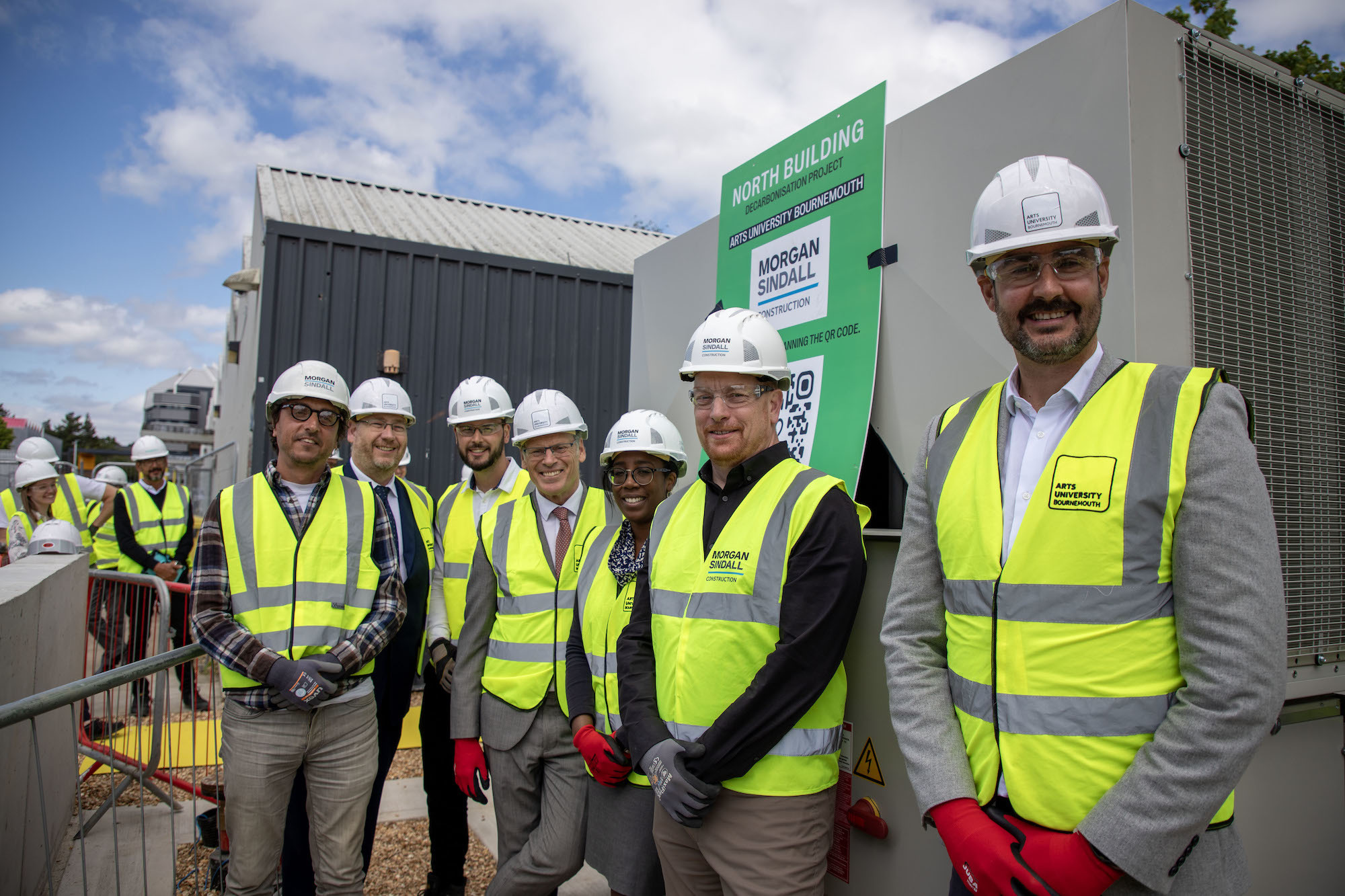 AUB Vice-Chancellor Professor P Gough and other members of AUB staff pose for a photo outside the Air Source Heat Pumps on AUB campus