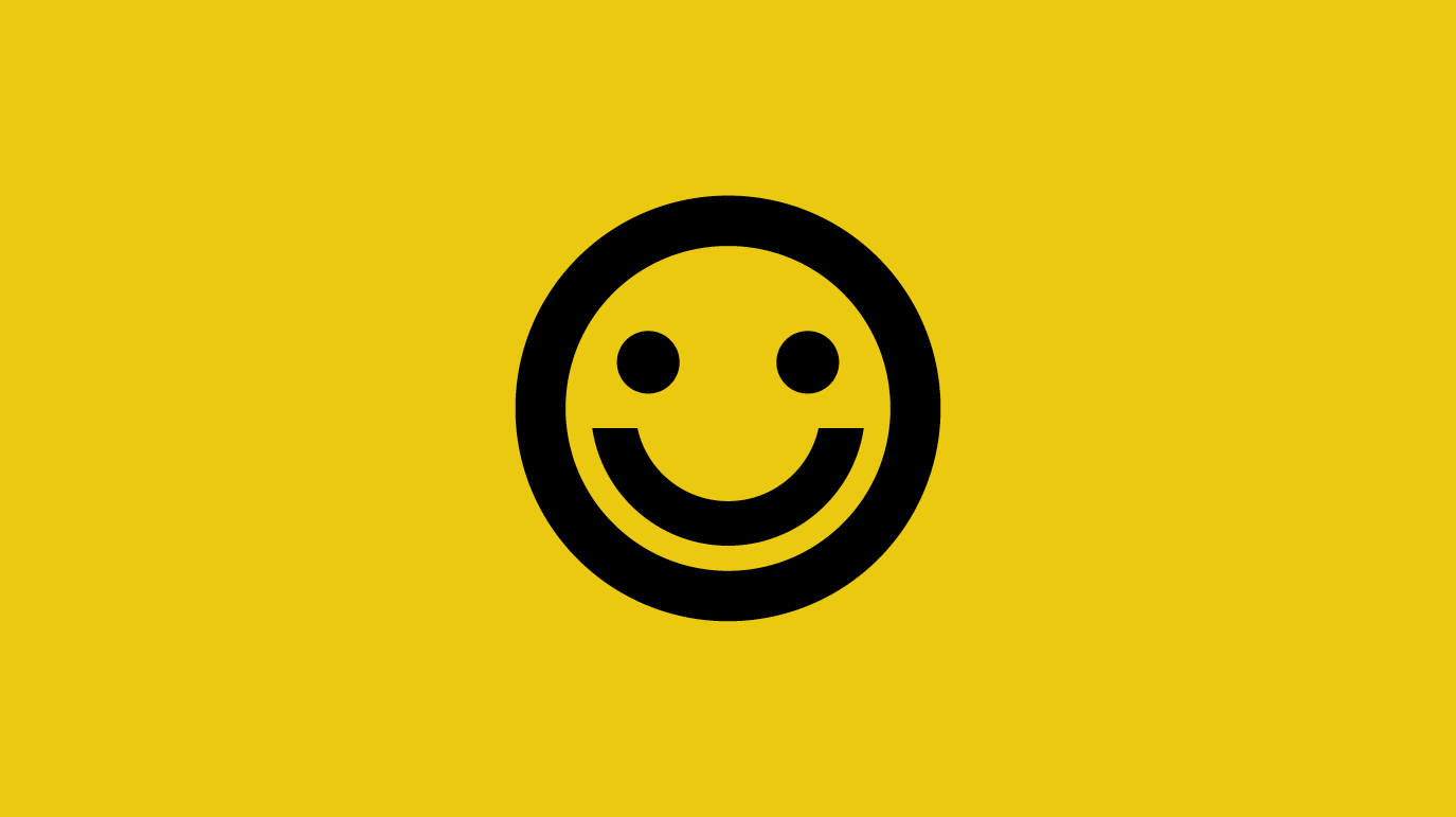 The symbol of a smiley face on a plain yellow background