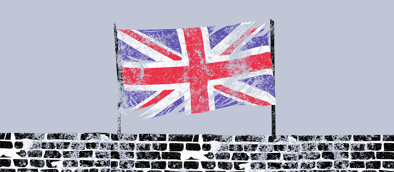 A Union Jack flag is held over a brick wall against a plain background