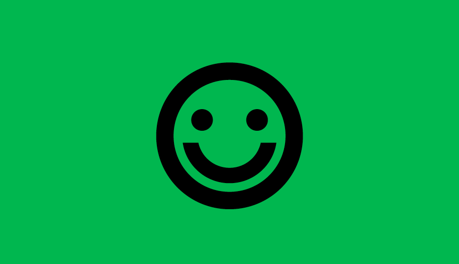 The symbol of a smiley face on a plain green background
