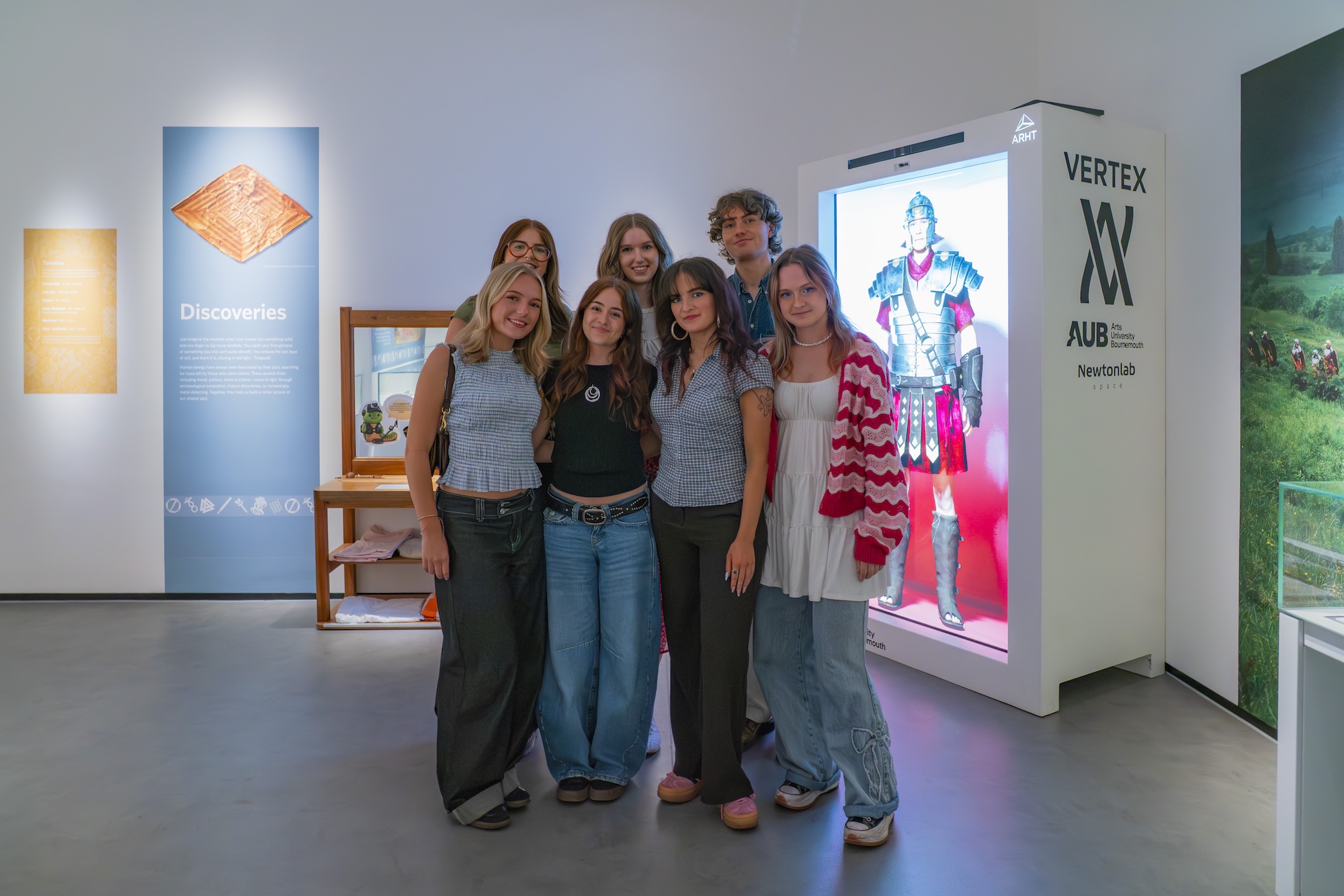 Group of seven BA (Hons) Creative Direction and BA (Hons) Events Management students posing for a photo in front of a Holobox with a Roman soldier on it.